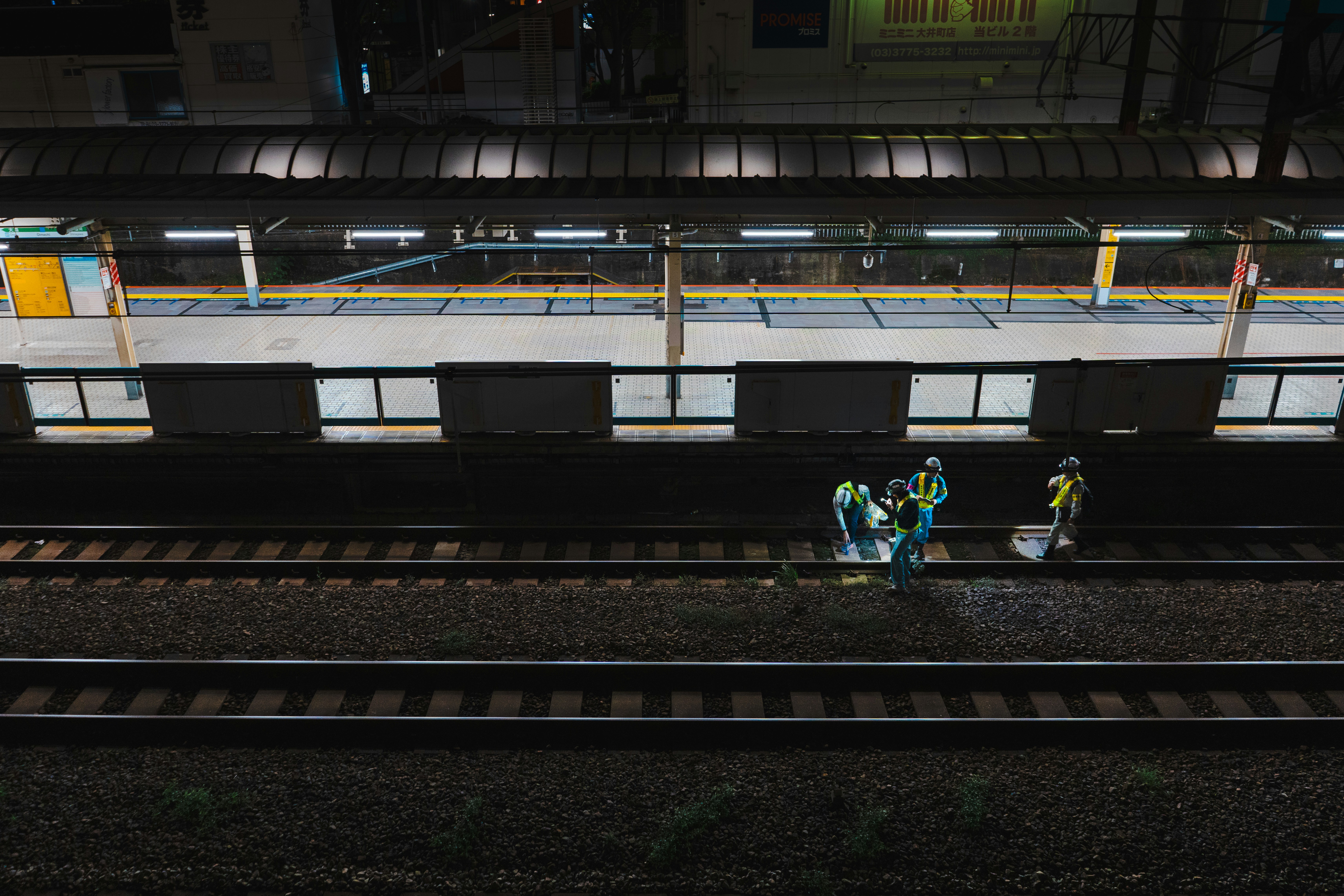 A couple of people standing on a train track