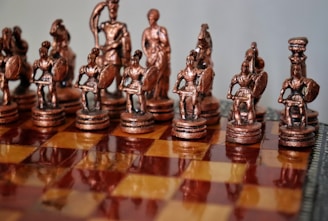 A close up of a chess board with figurines on it