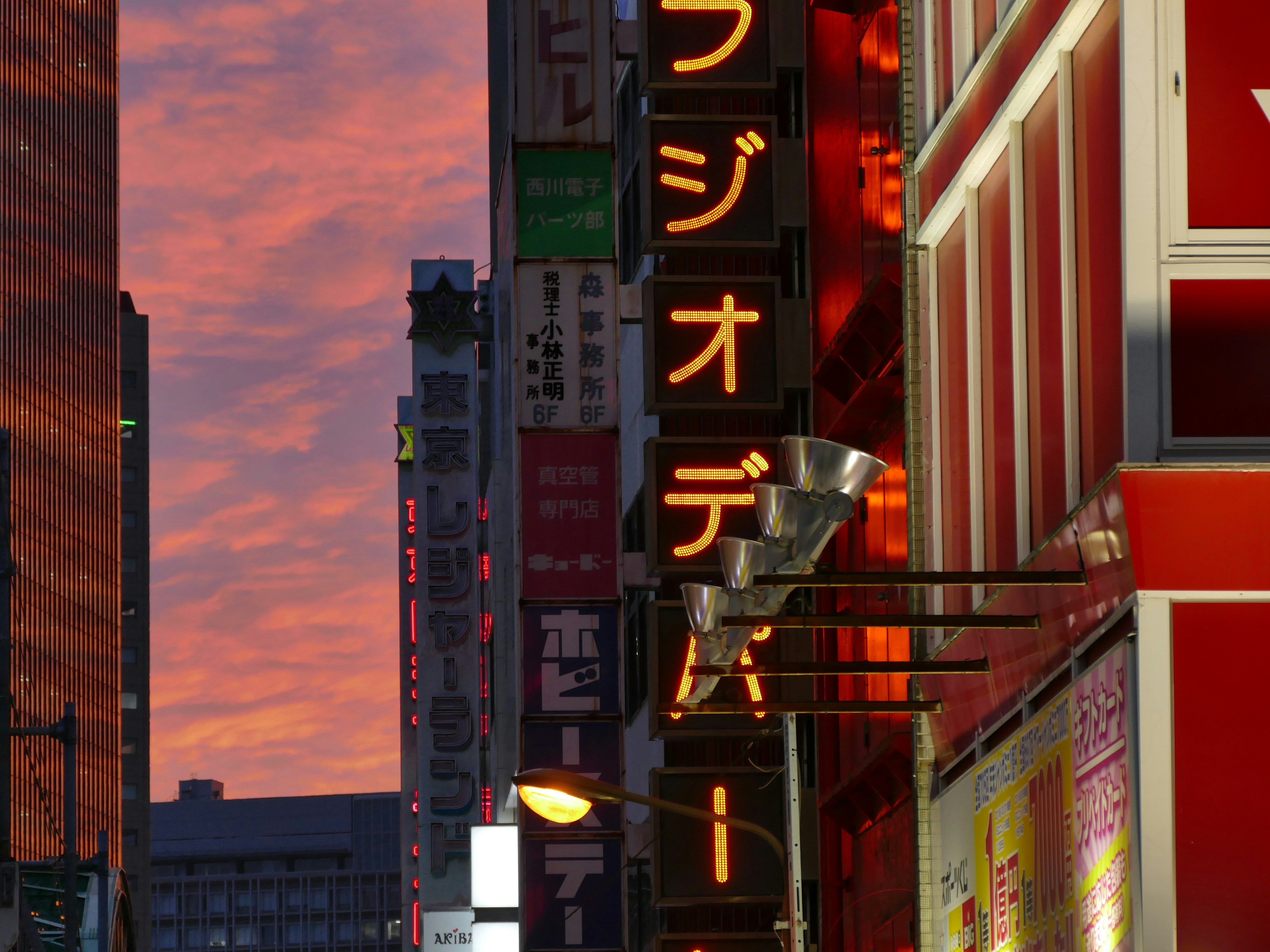A city street filled with lots of tall buildings