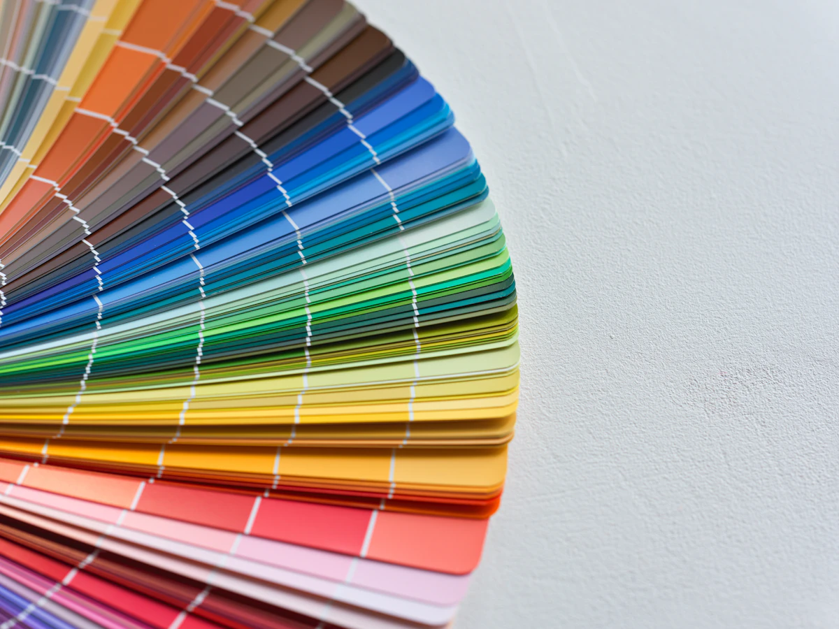 A tray holding many different colors of paint samples, similar to a reference library of past project colors used to calibrate a Delta E tolerance