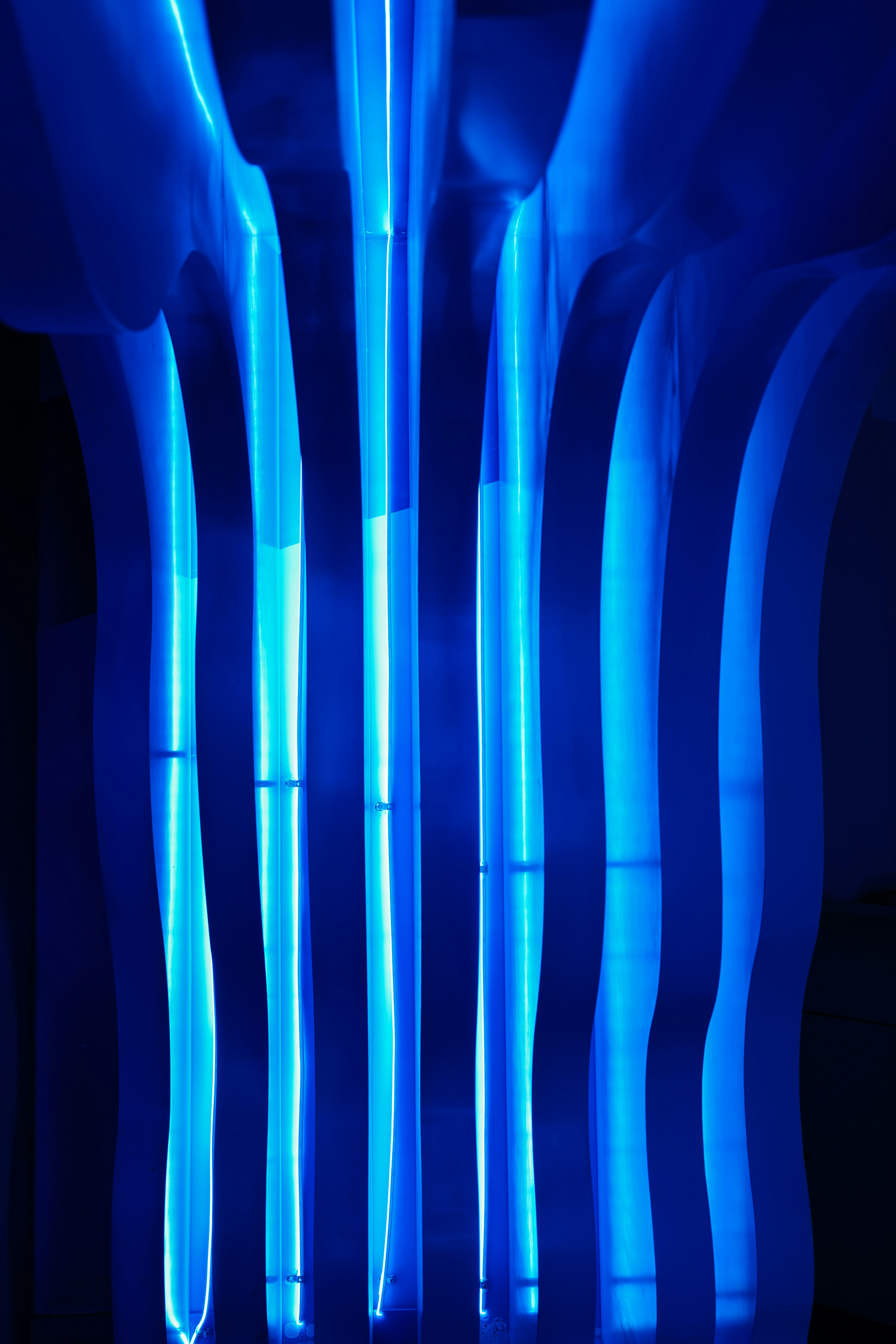 A room with blue lights and a black background