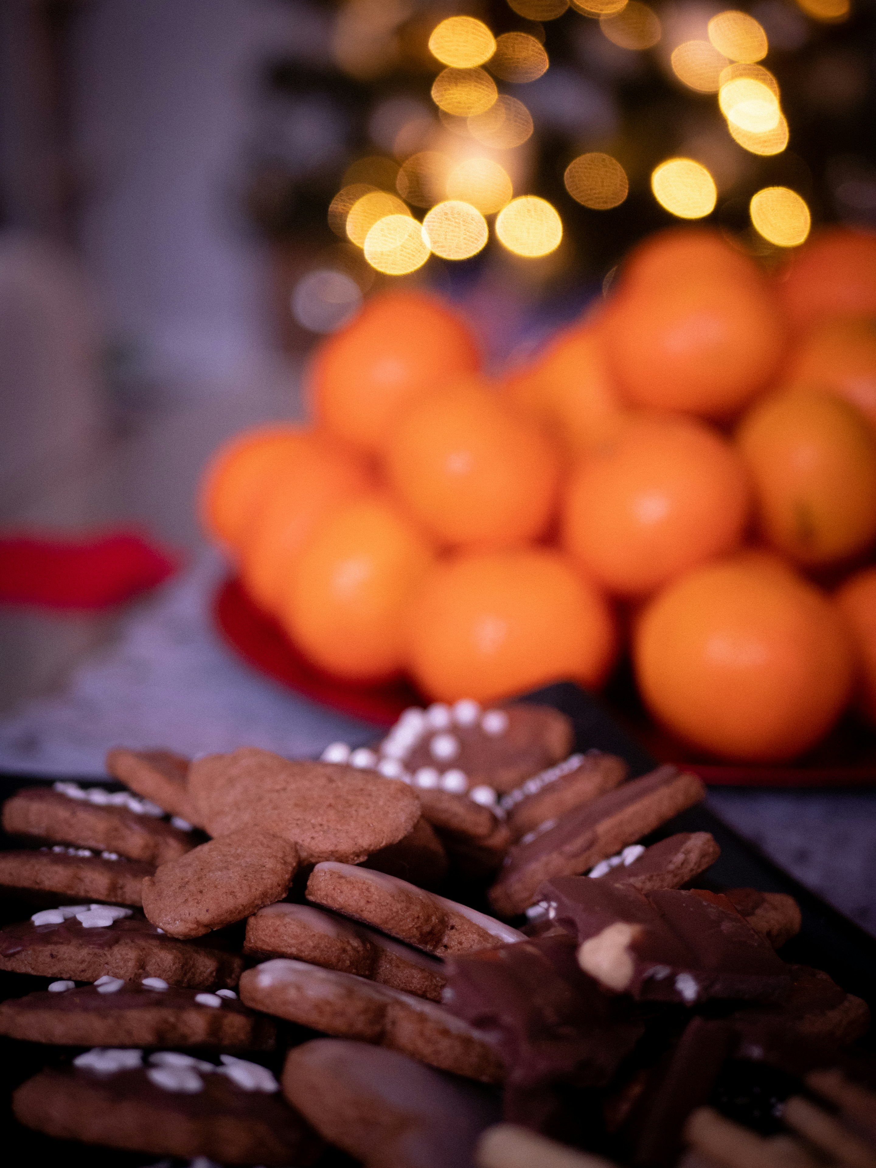 A plate of cookies and oranges on a table