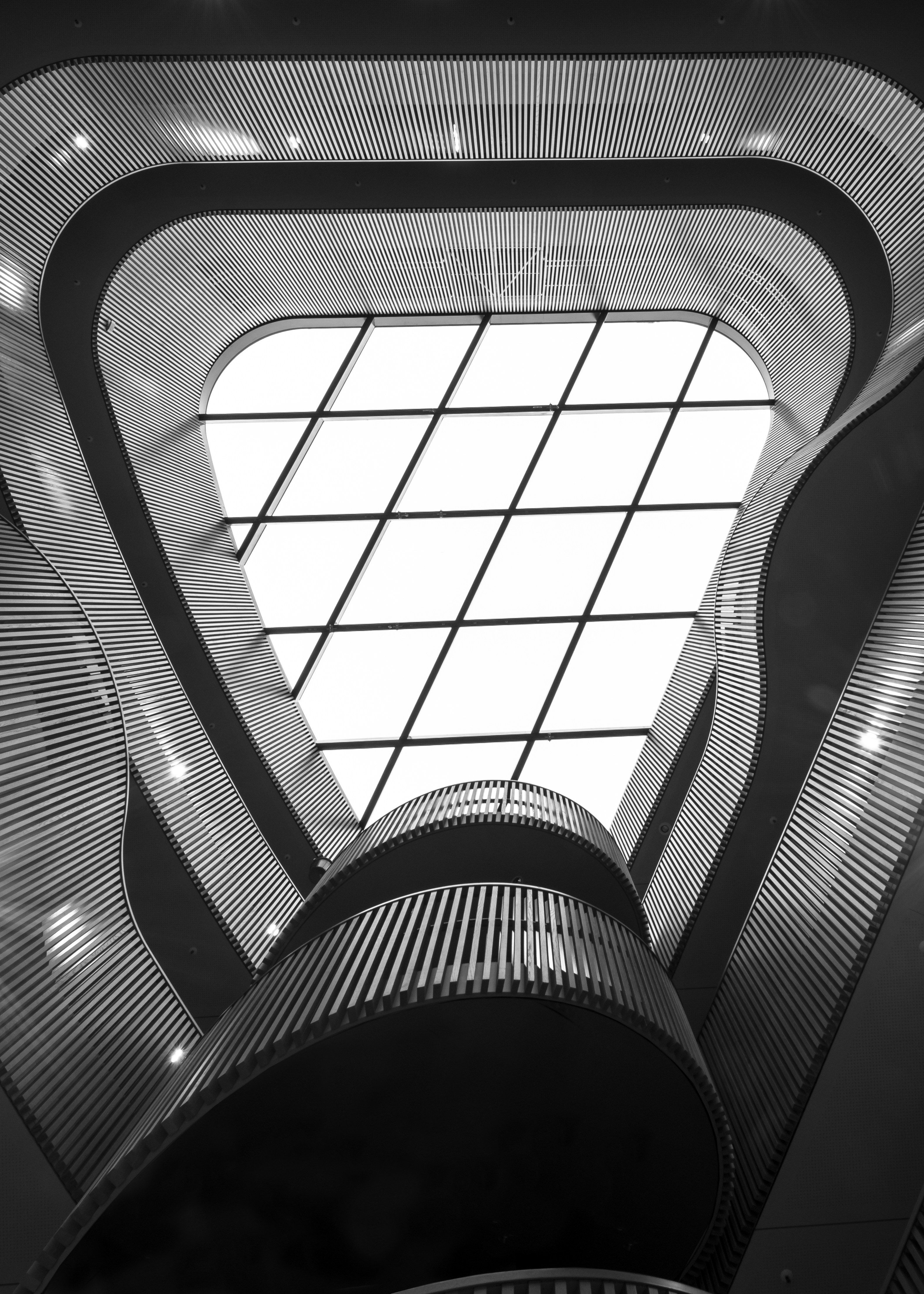 A black and white photo of an escalator