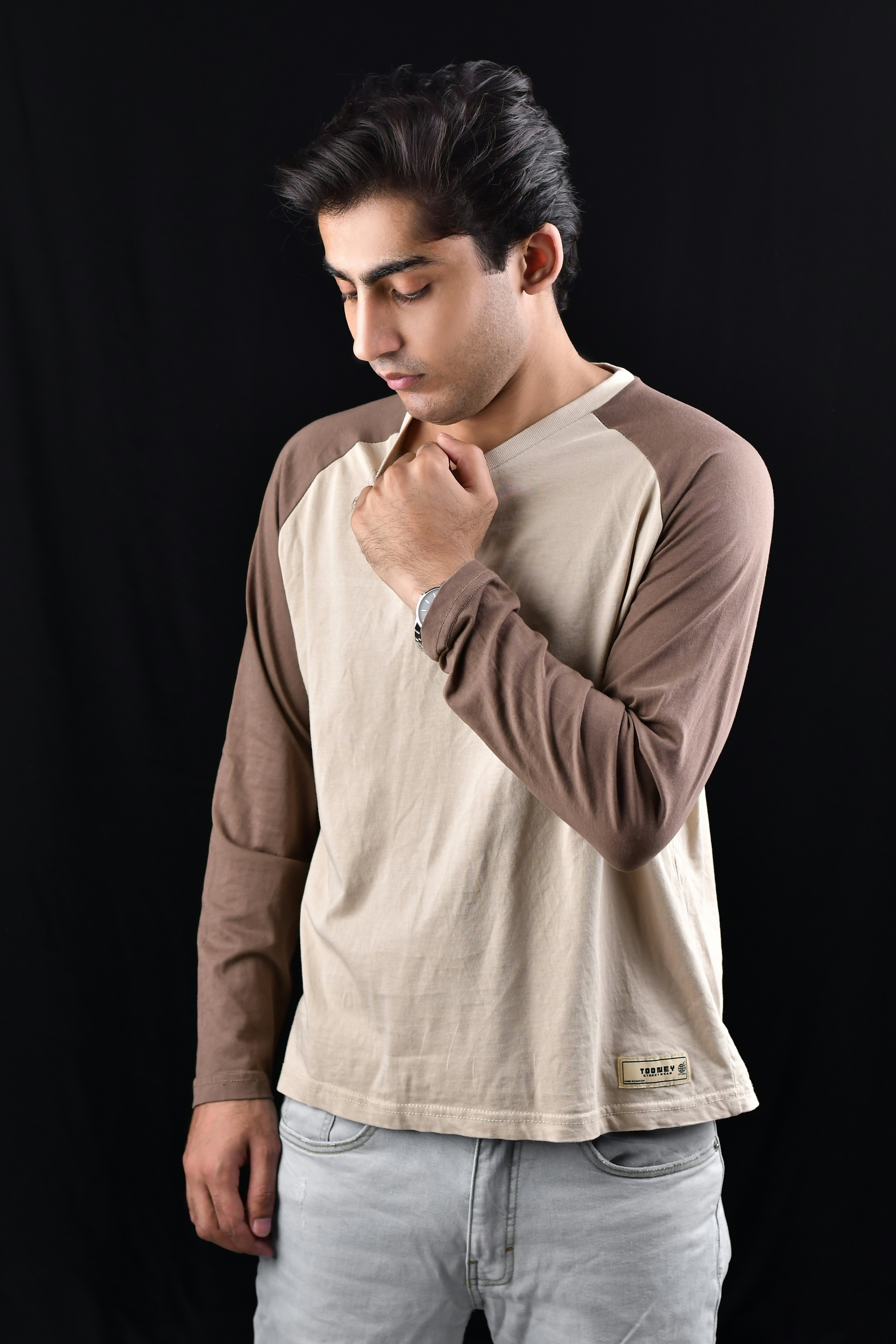 A man standing in front of a black background