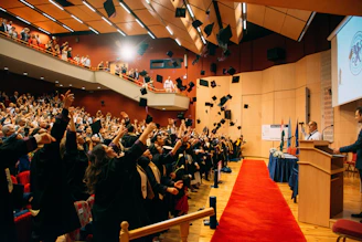 A man standing at a podium in front of a crowd of people