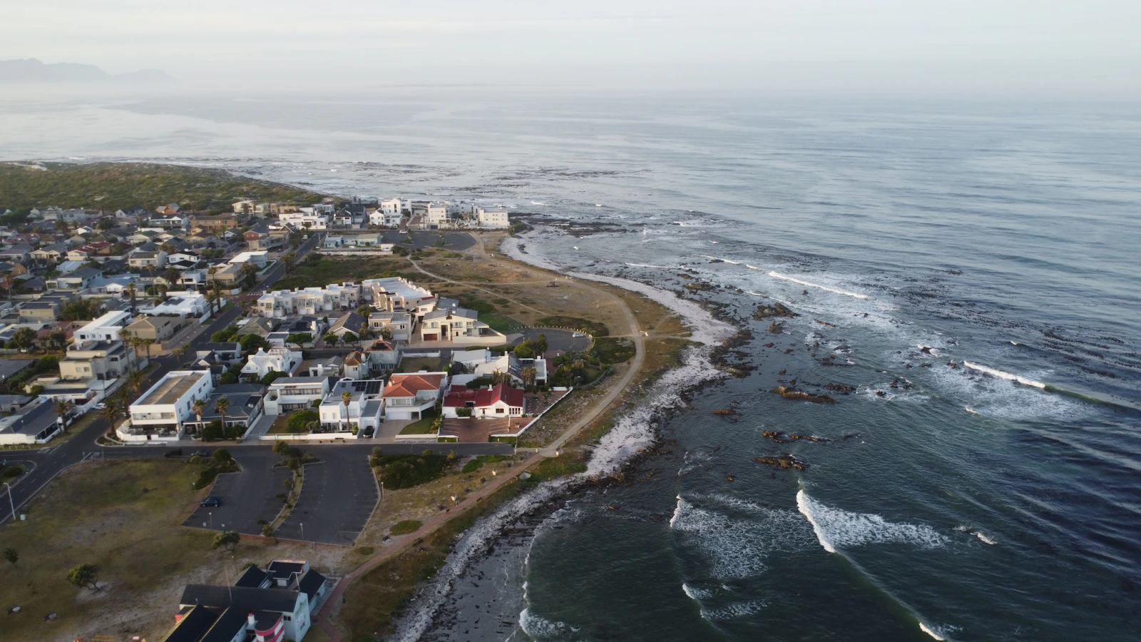 Aerial view of a small coastal town beside the ocean