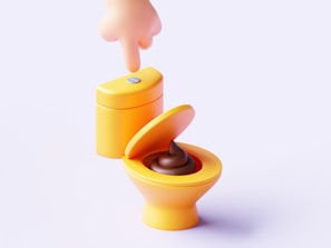 A toy toilet with the lid open and a person sticking their finger in the toilet