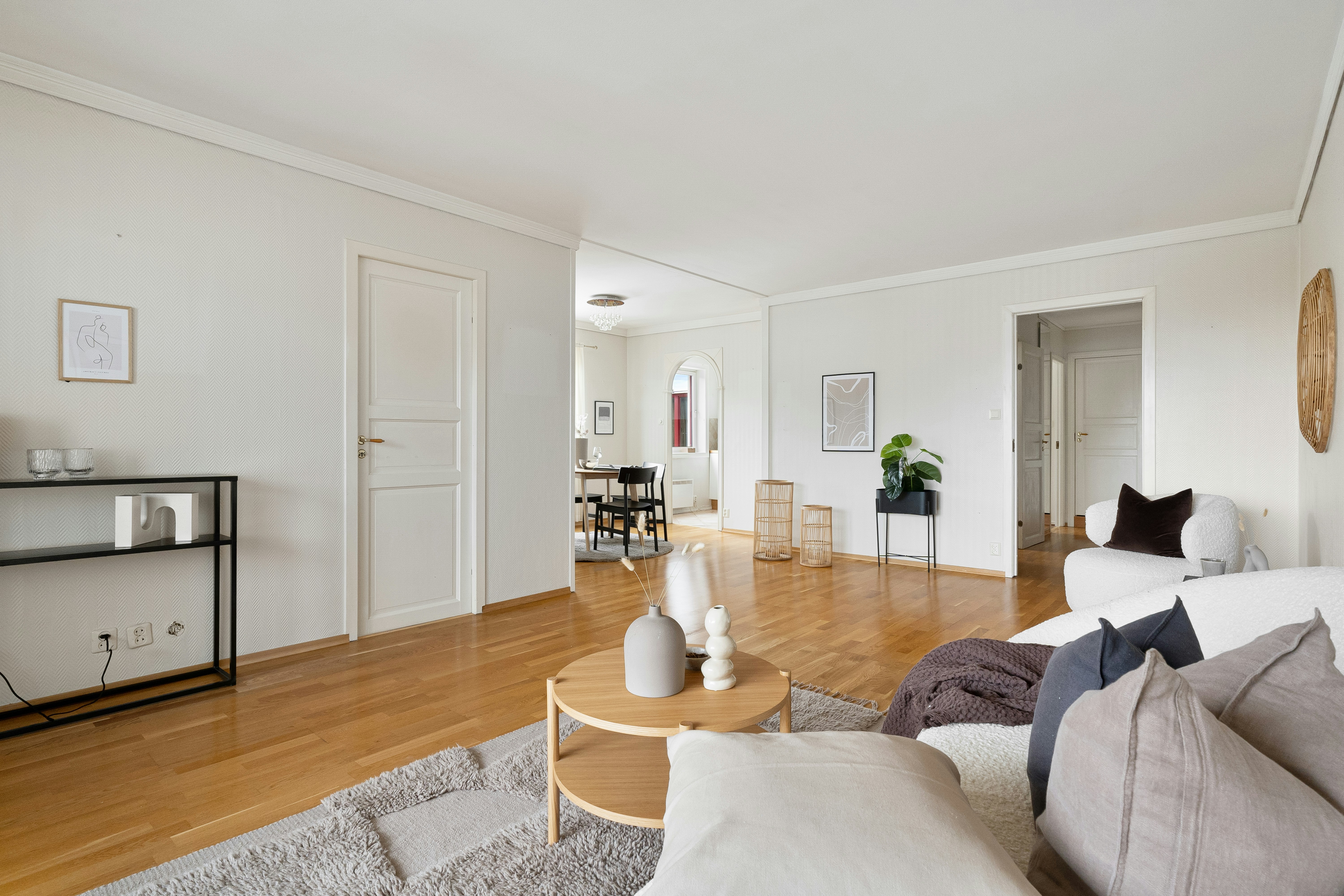 A living room filled with furniture and a wooden floor