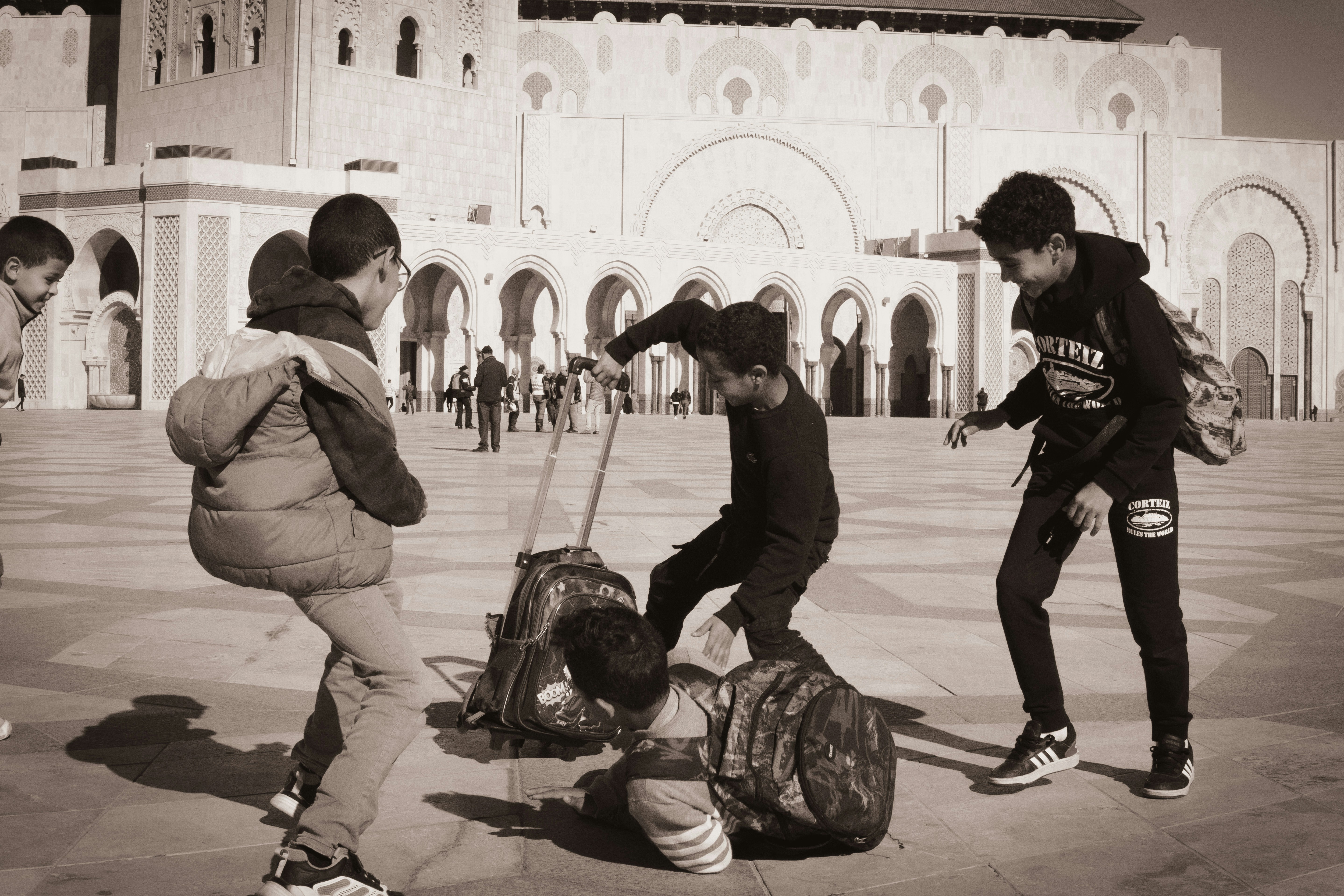 A group of people standing around a luggage bag
