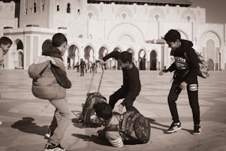 A group of people standing around a luggage bag