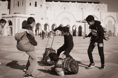 A group of people standing around a luggage bag