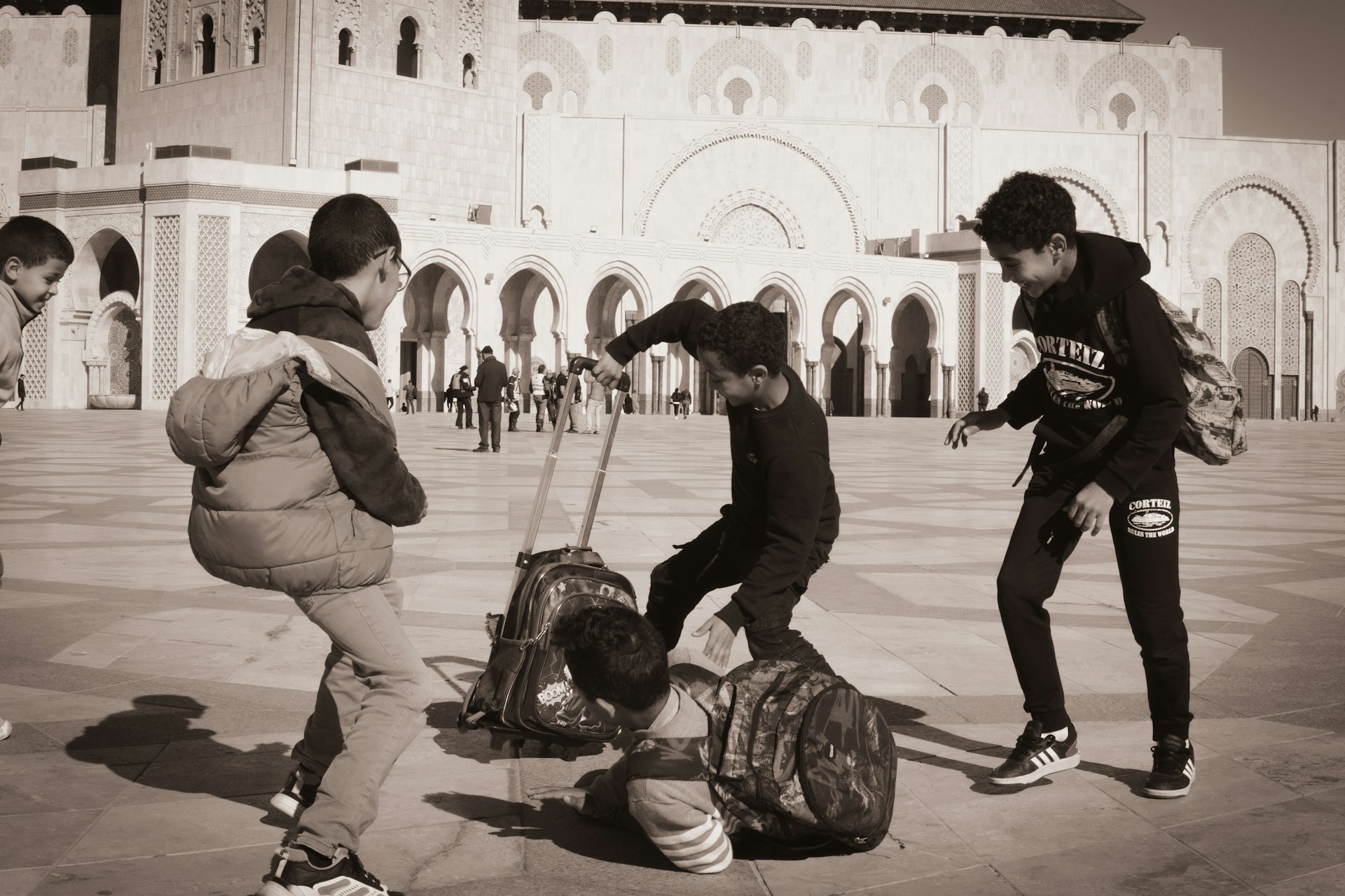 A group of people standing around a luggage bag