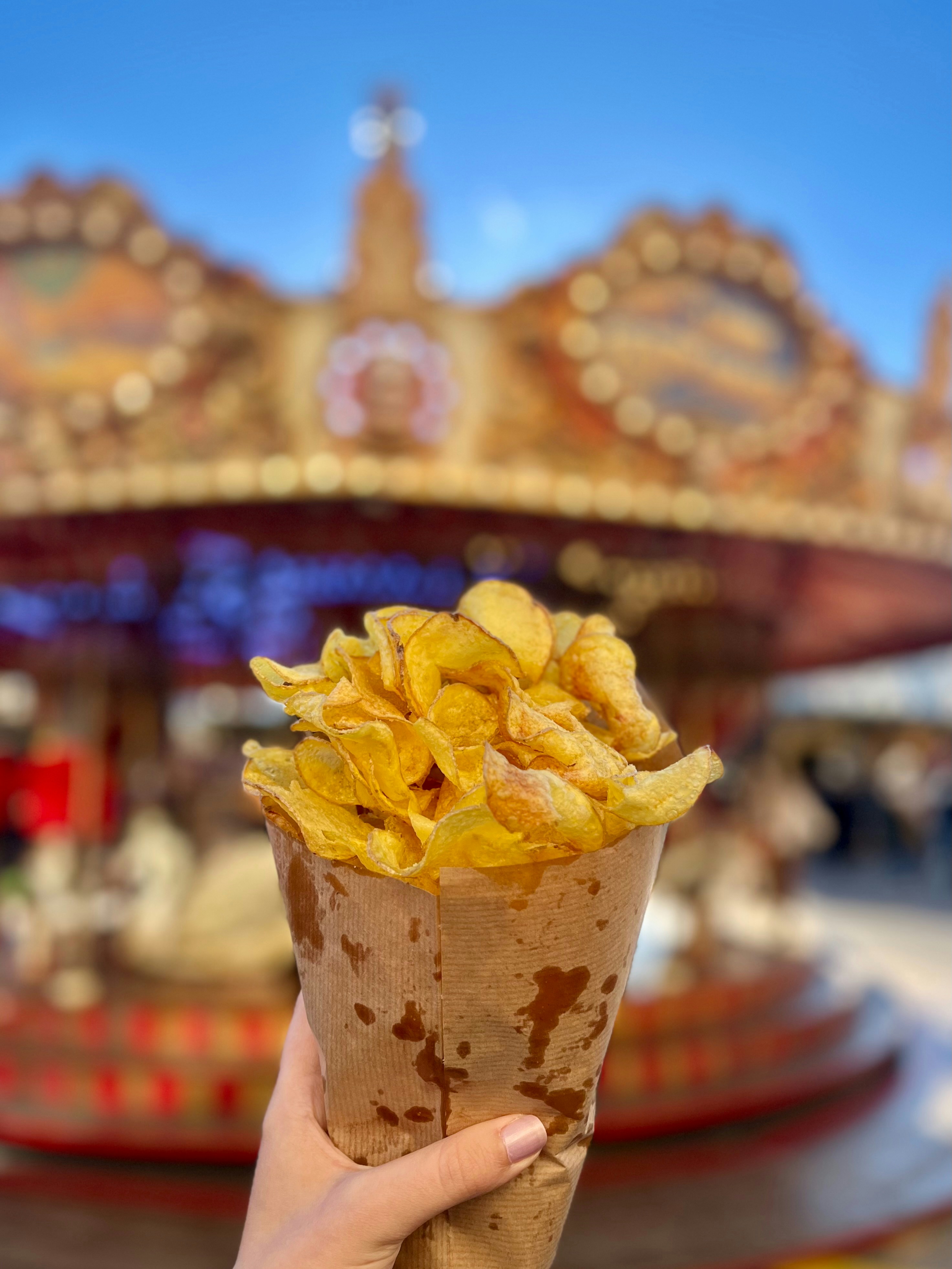 Crispy chips in a paper cone with ketchup on the side