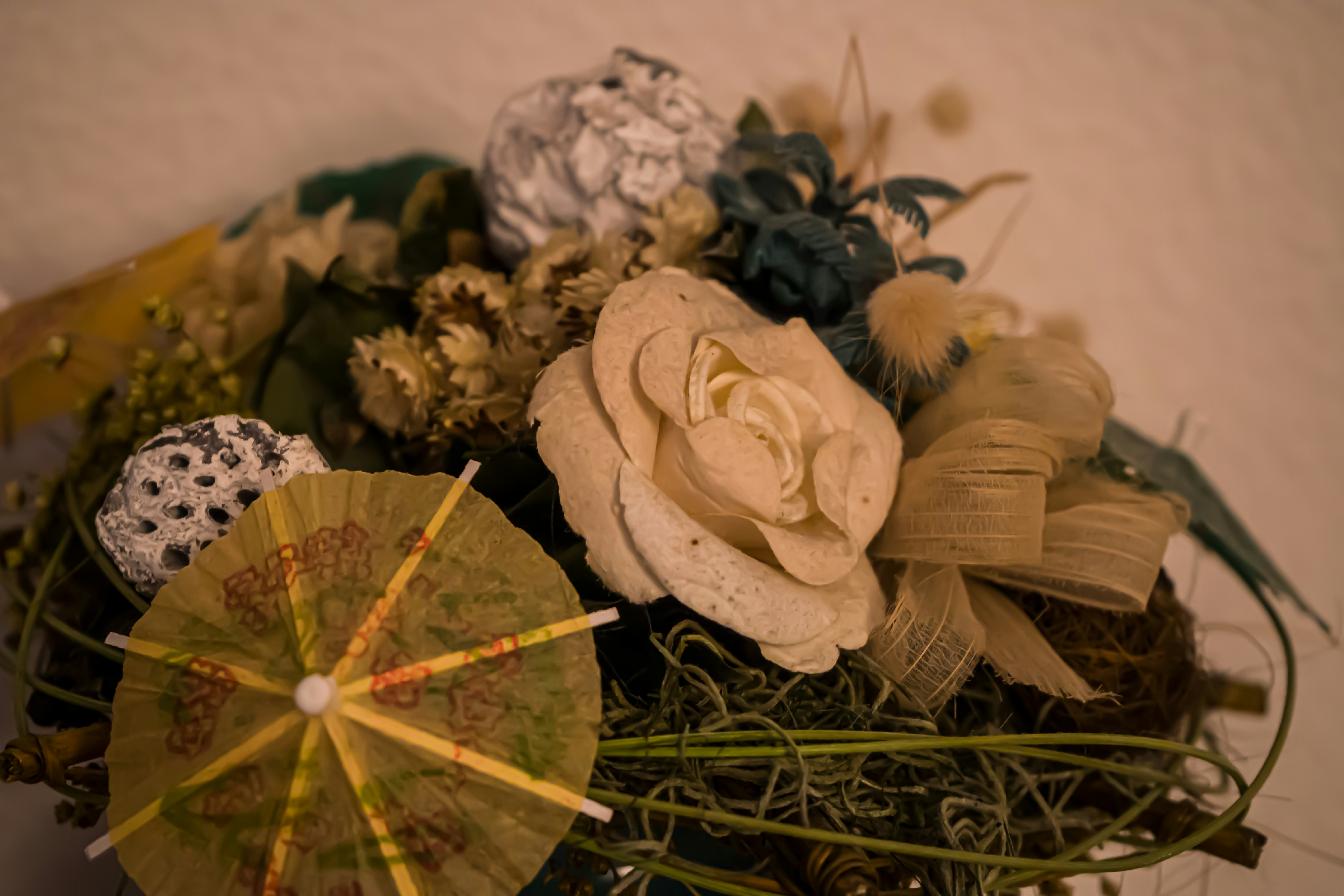 A bouquet of flowers and an umbrella on a table