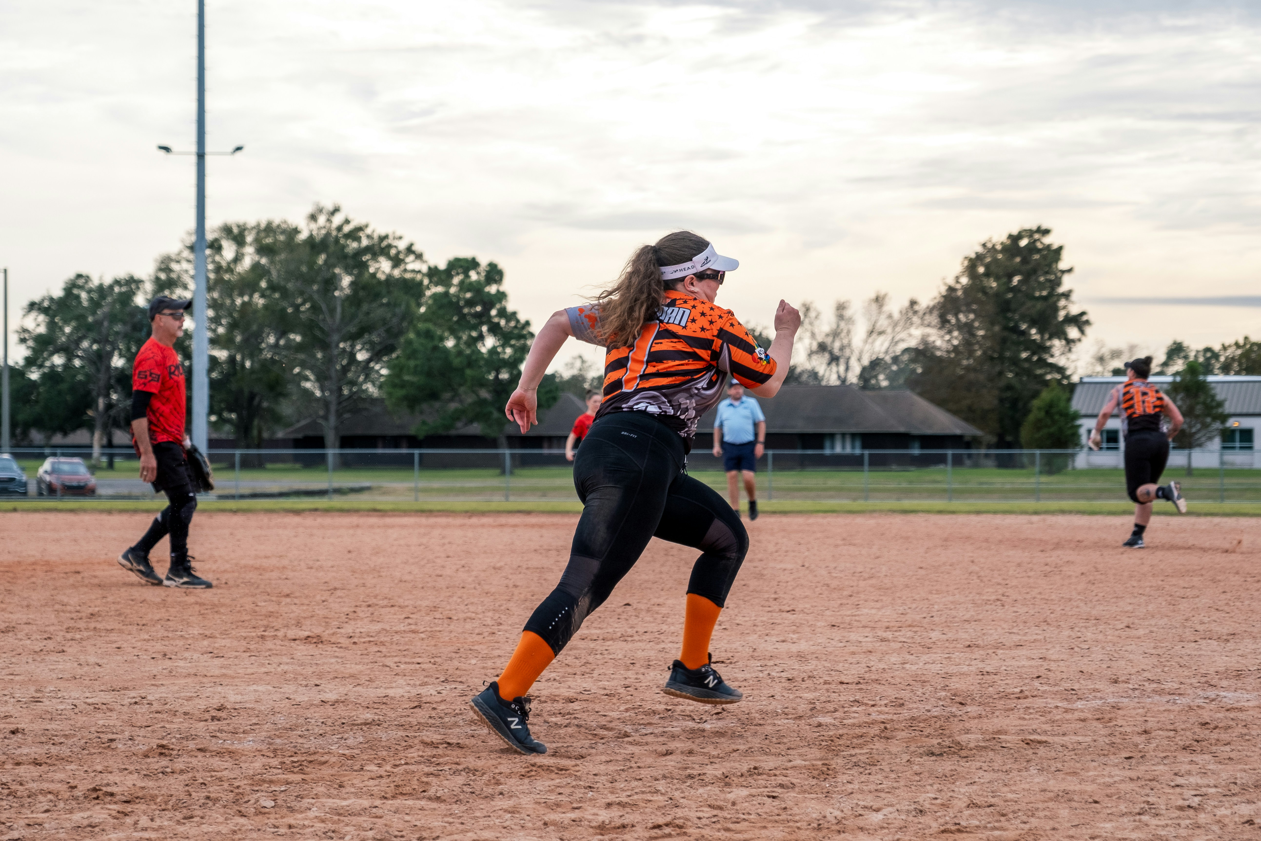 A group of people playing a game of softball