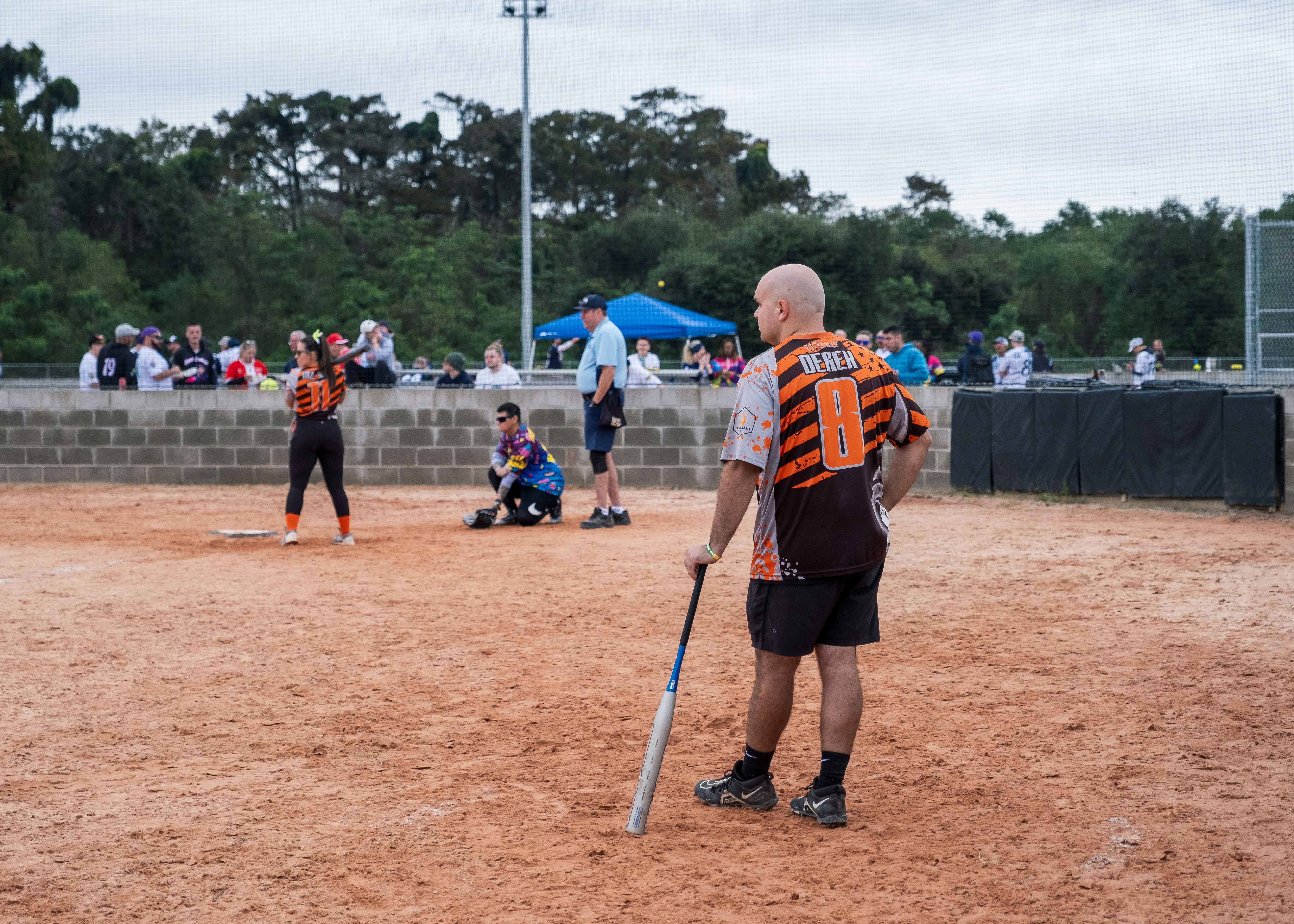 A man holding a baseball bat on top of a field