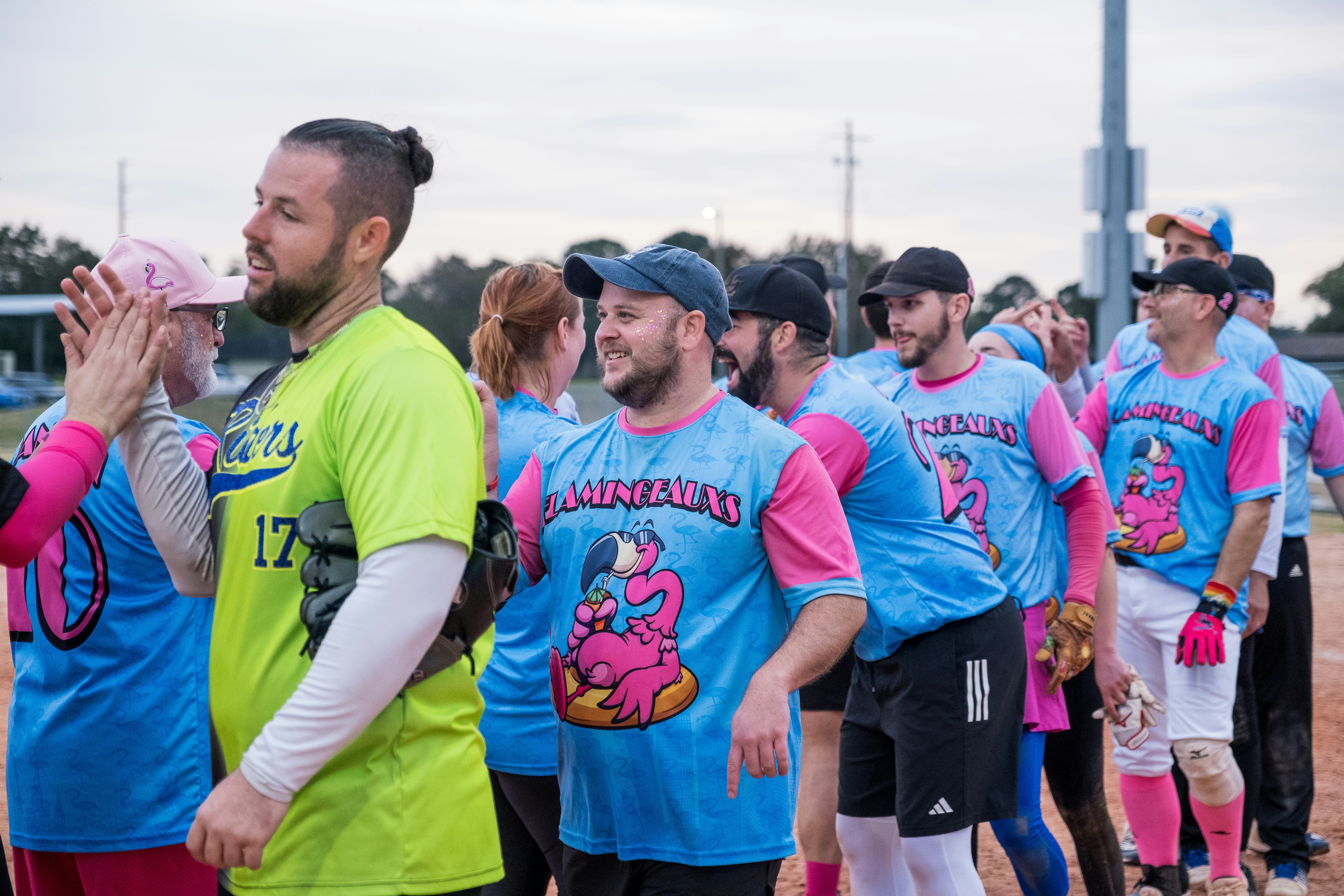 A group of people standing on top of a baseball field