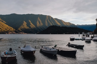 A group of boats floating on top of a lake