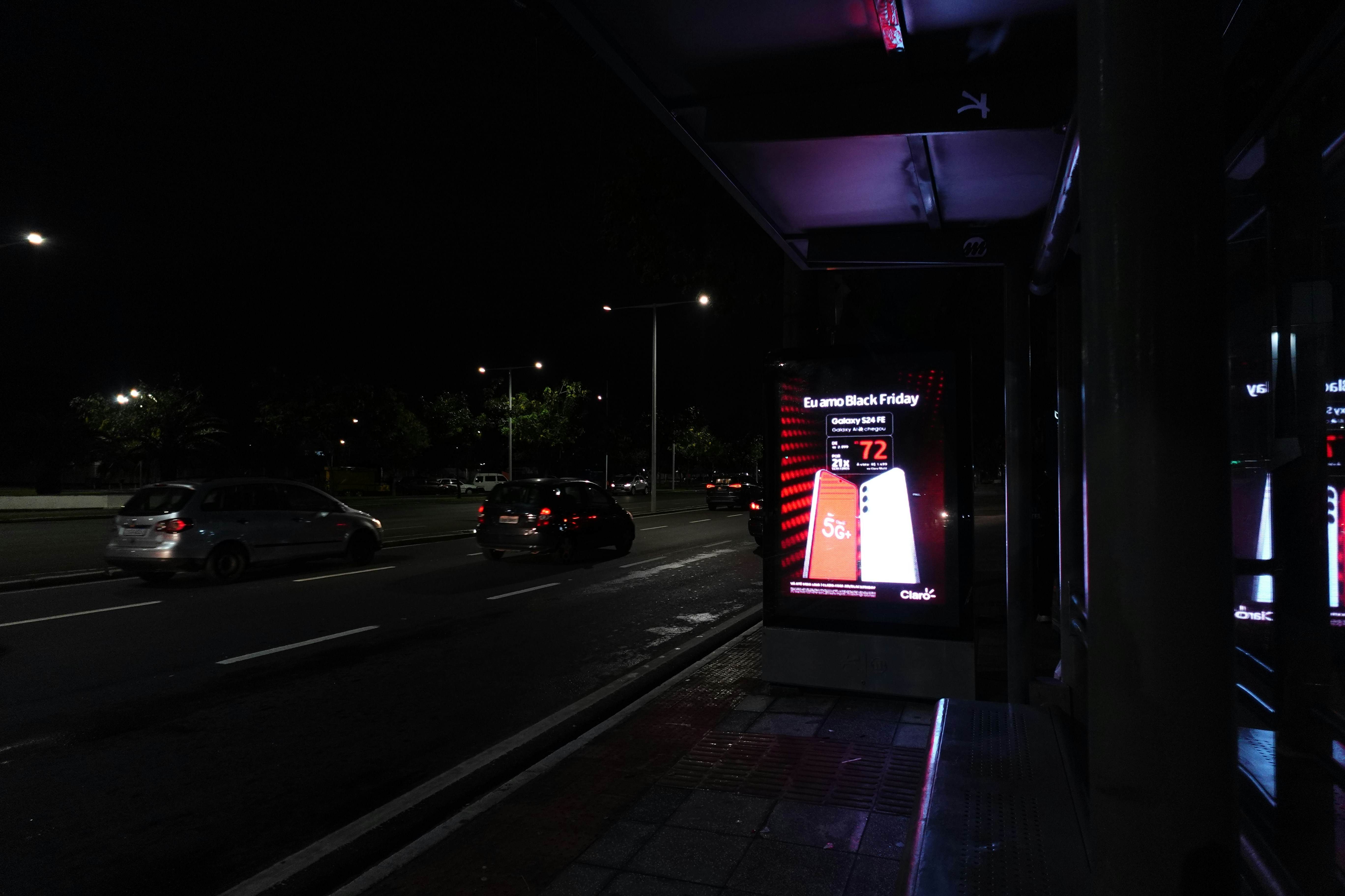 Chevy Bolt EV plugged in at a public charging station in a city parking lot