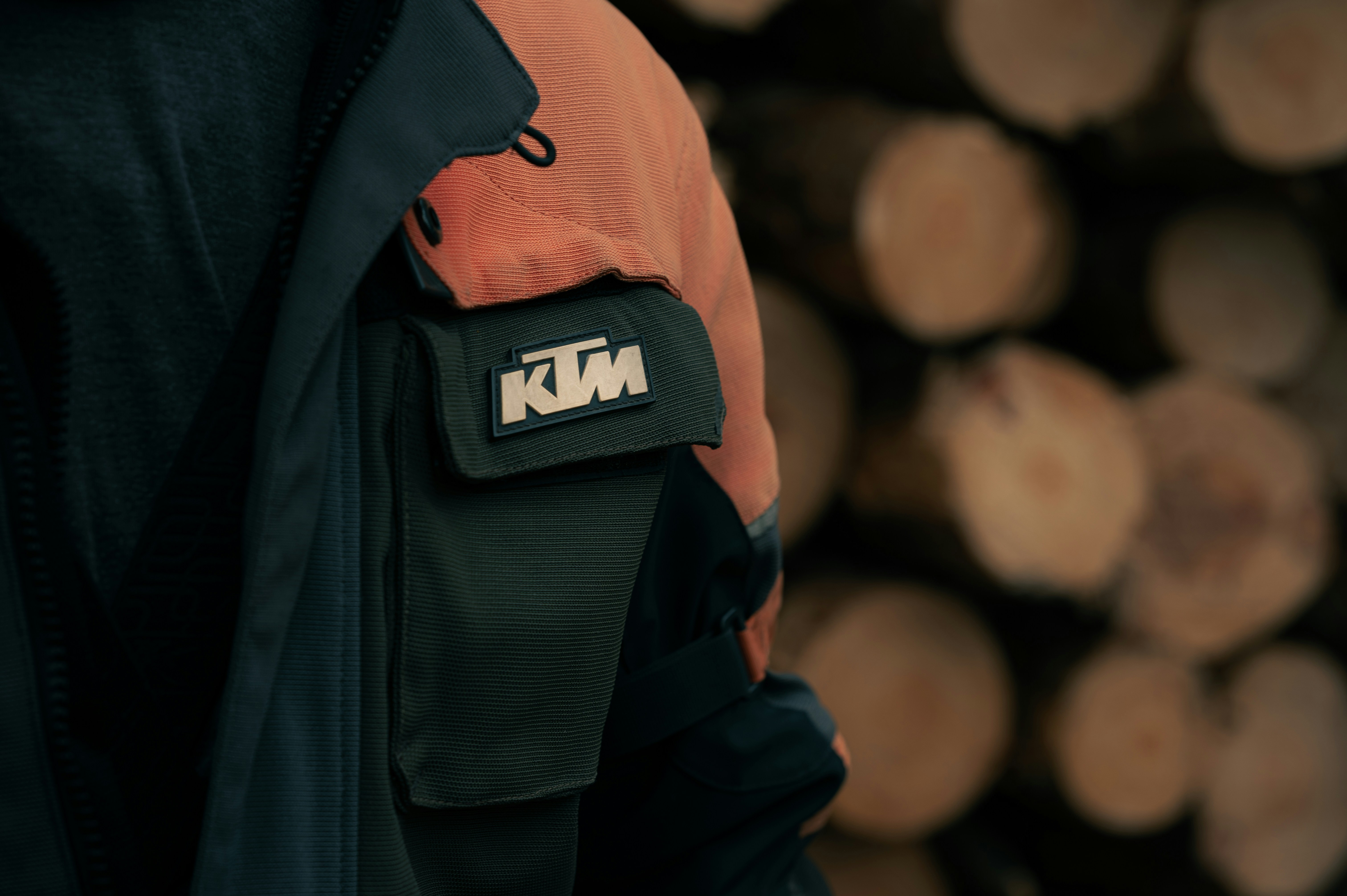 A person wearing a jacket with a patch on it