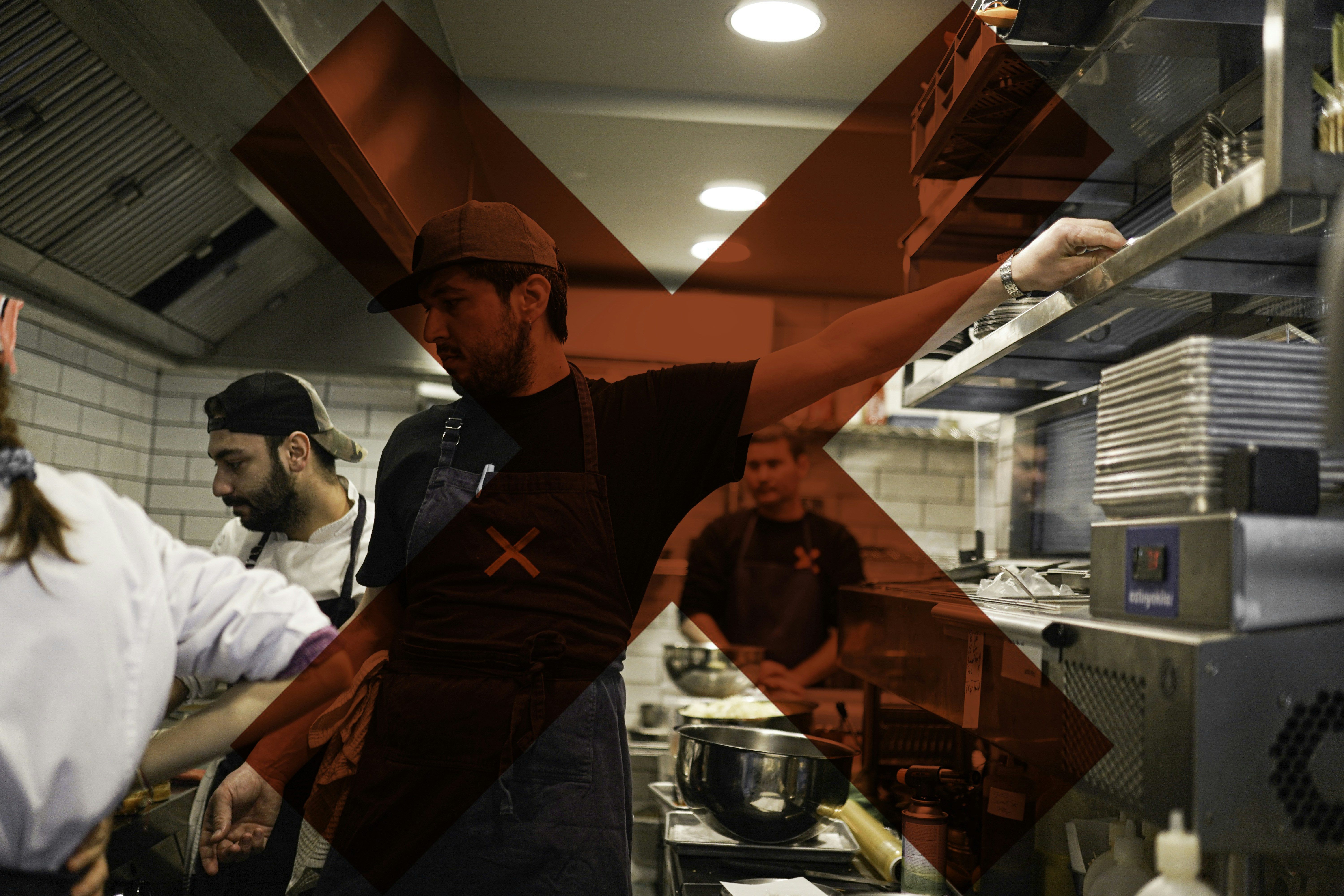 A group of people in a kitchen preparing food