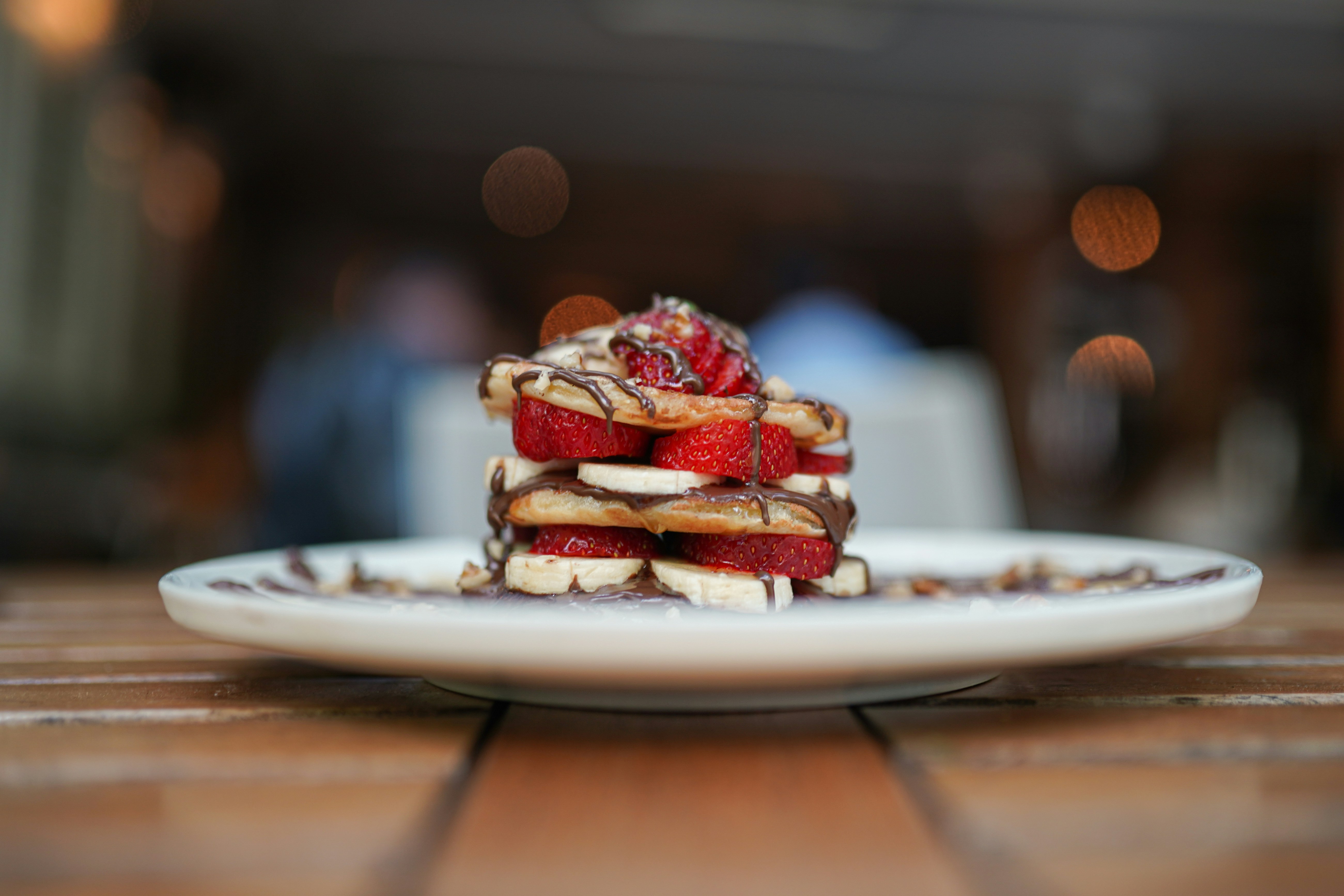 A white plate topped with a stack of desserts