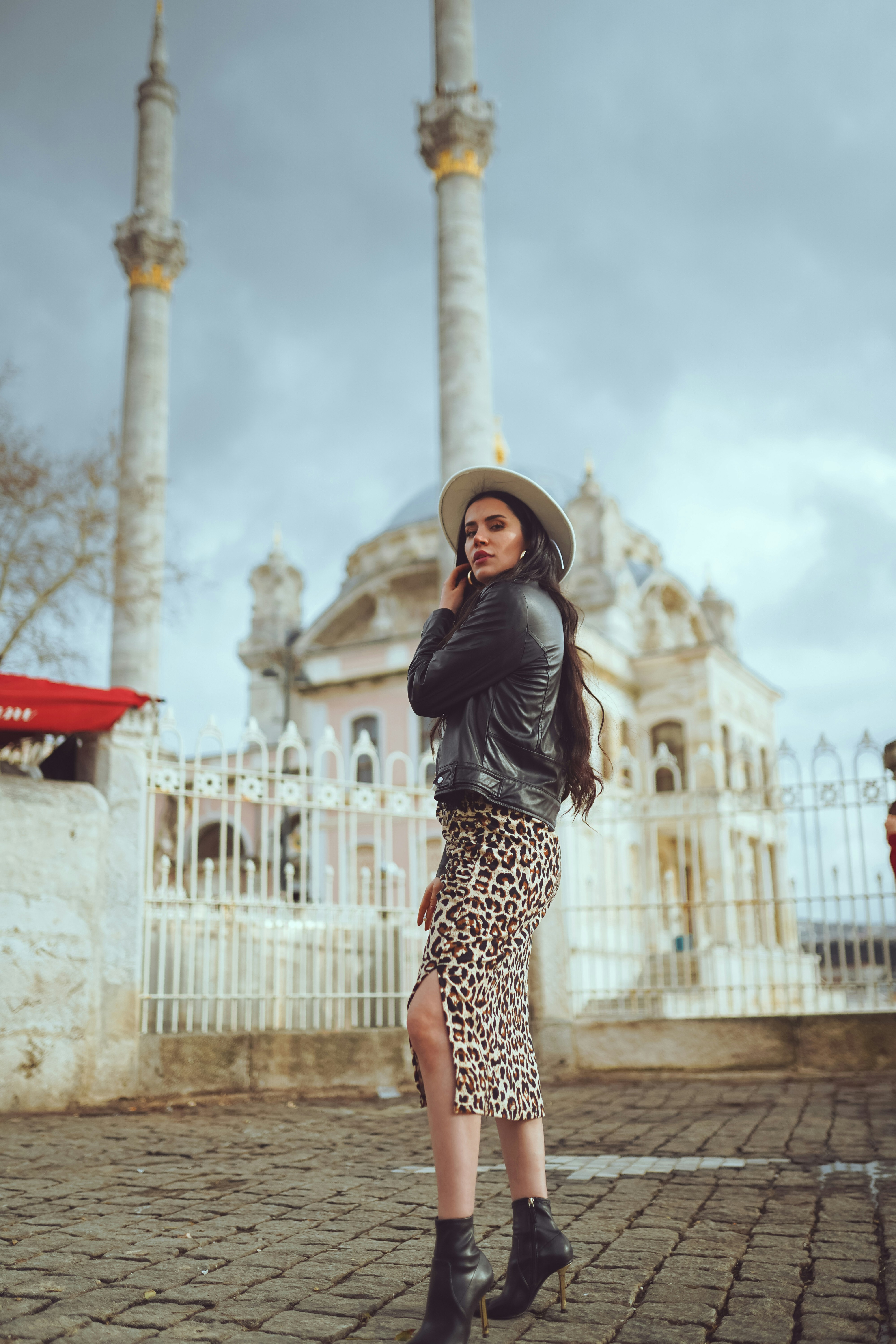 A woman standing in front of a white building