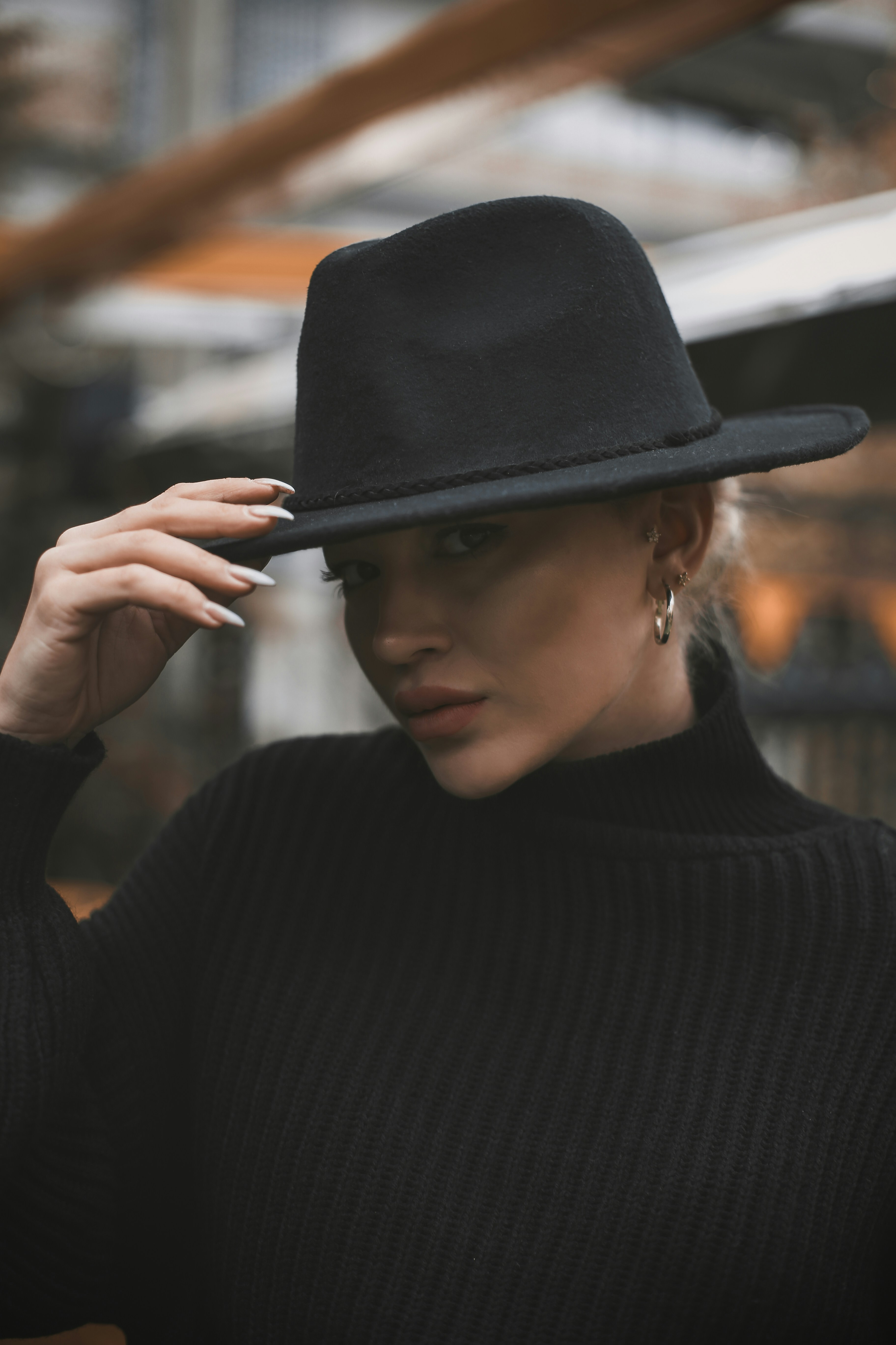 A woman wearing a black hat and a black sweater