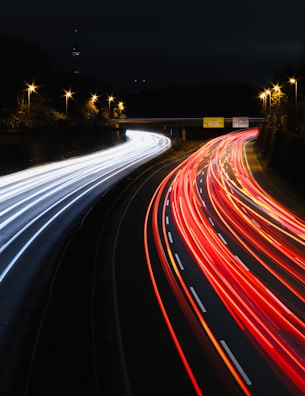 A long exposure photo of a highway at night