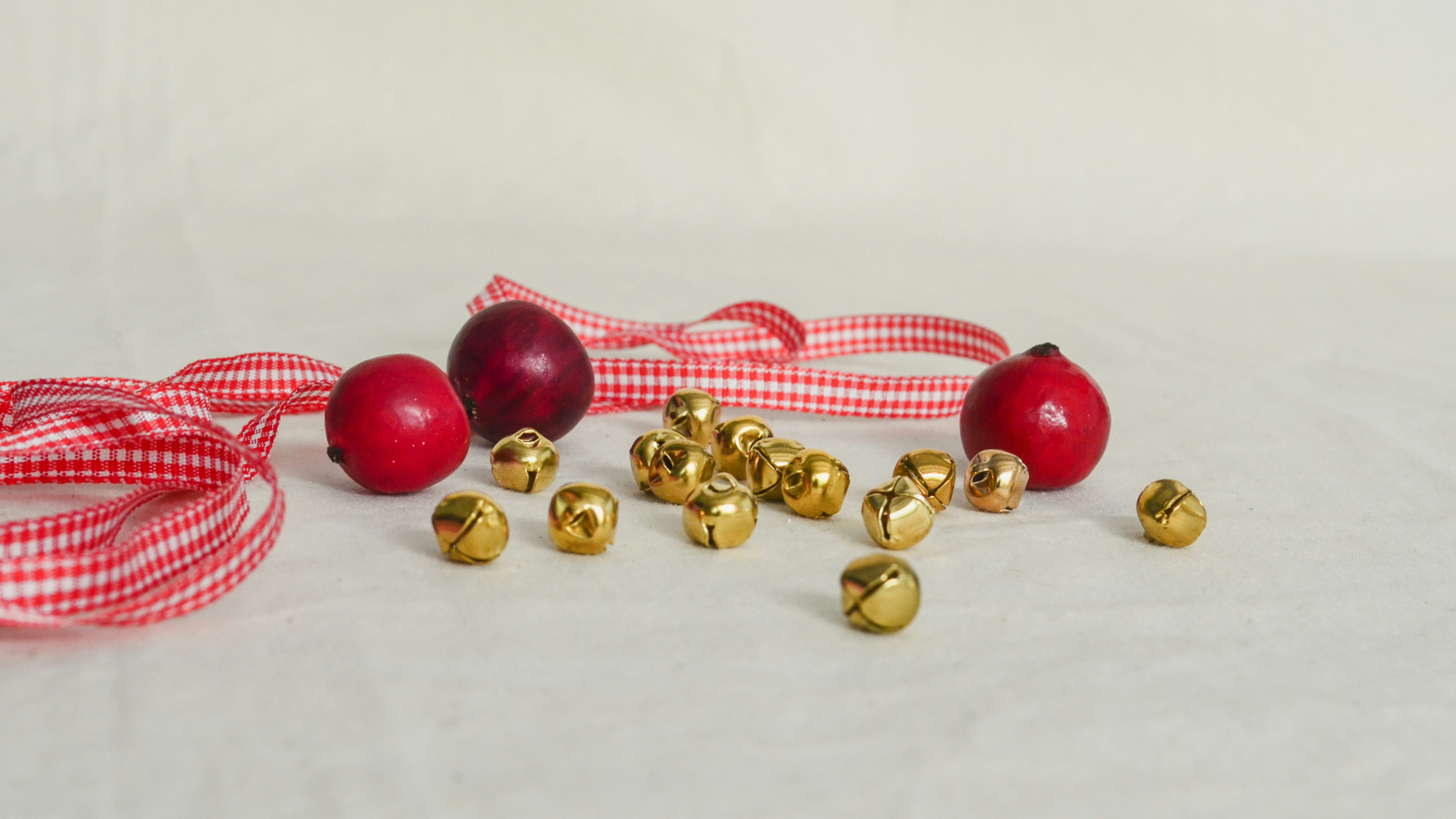 A white table topped with red and gold ornaments