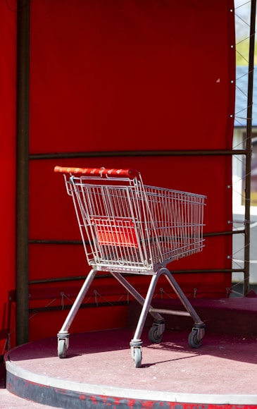 A shopping cart sitting on the side of a building