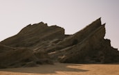 A large rock formation in the middle of a desert