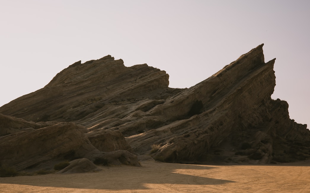 A large rock formation in the middle of a desert