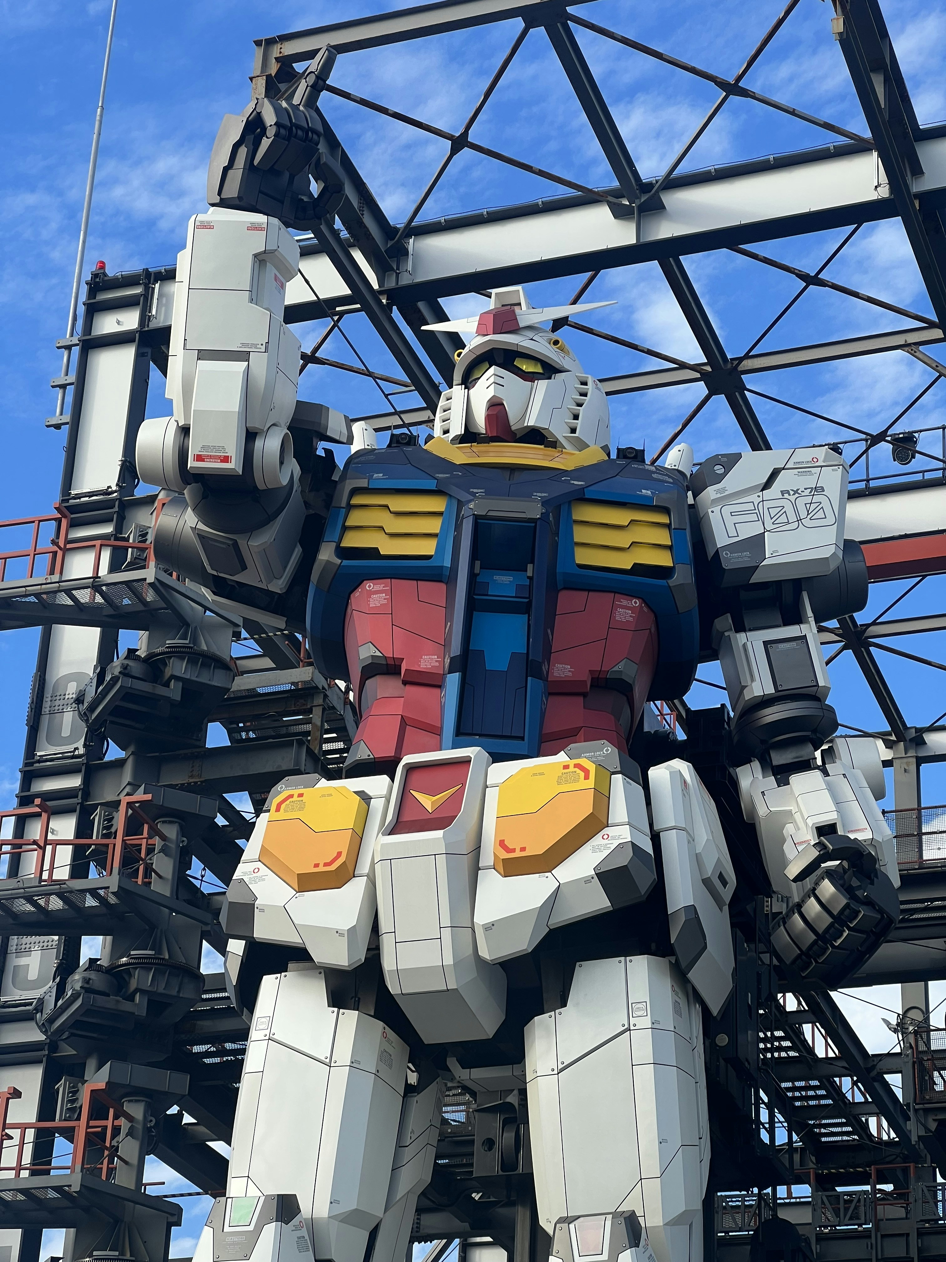 A giant robot that is standing next to a building