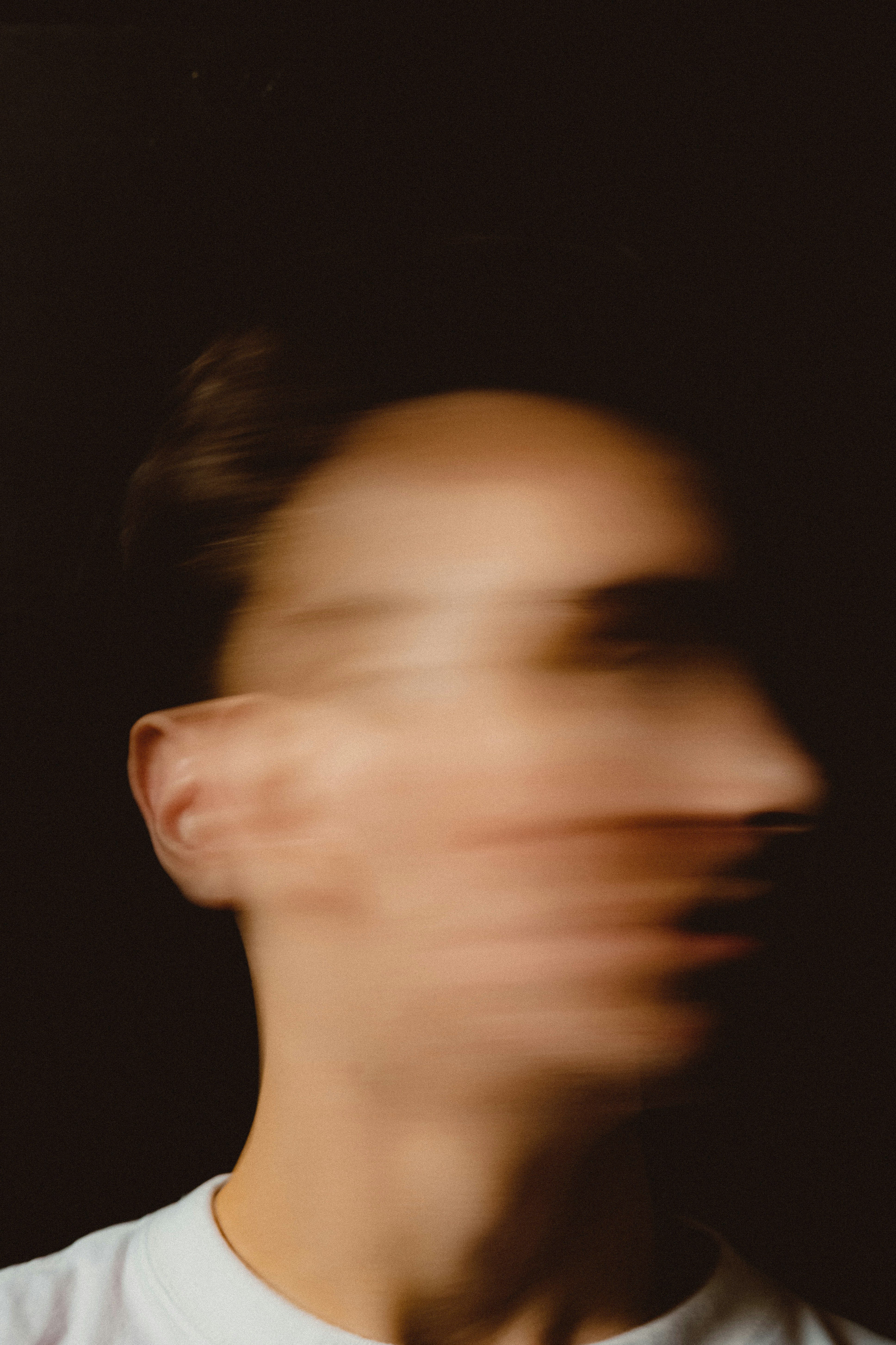 A blurry photo of a man in a white shirt