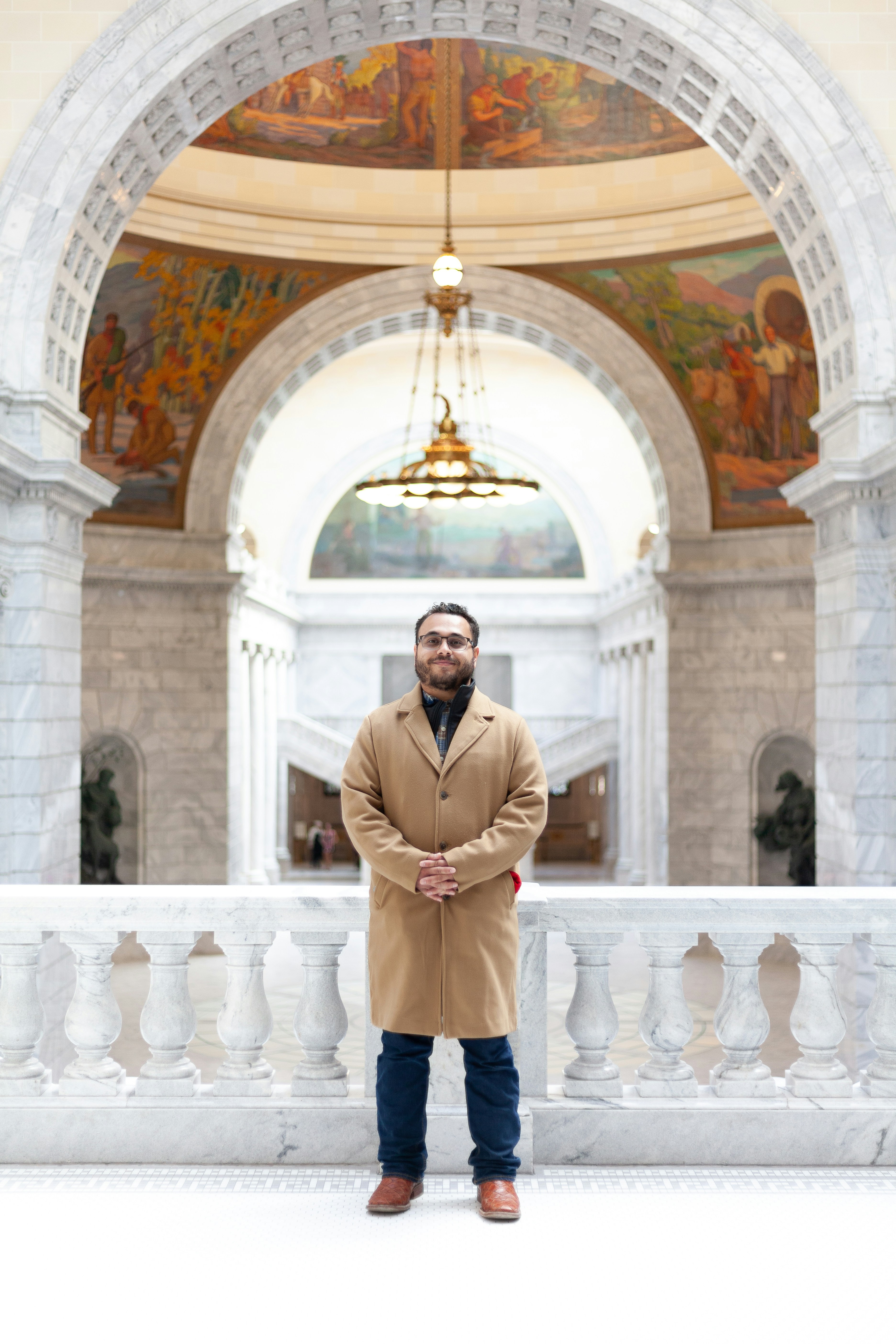 A man standing in front of a painting in a building