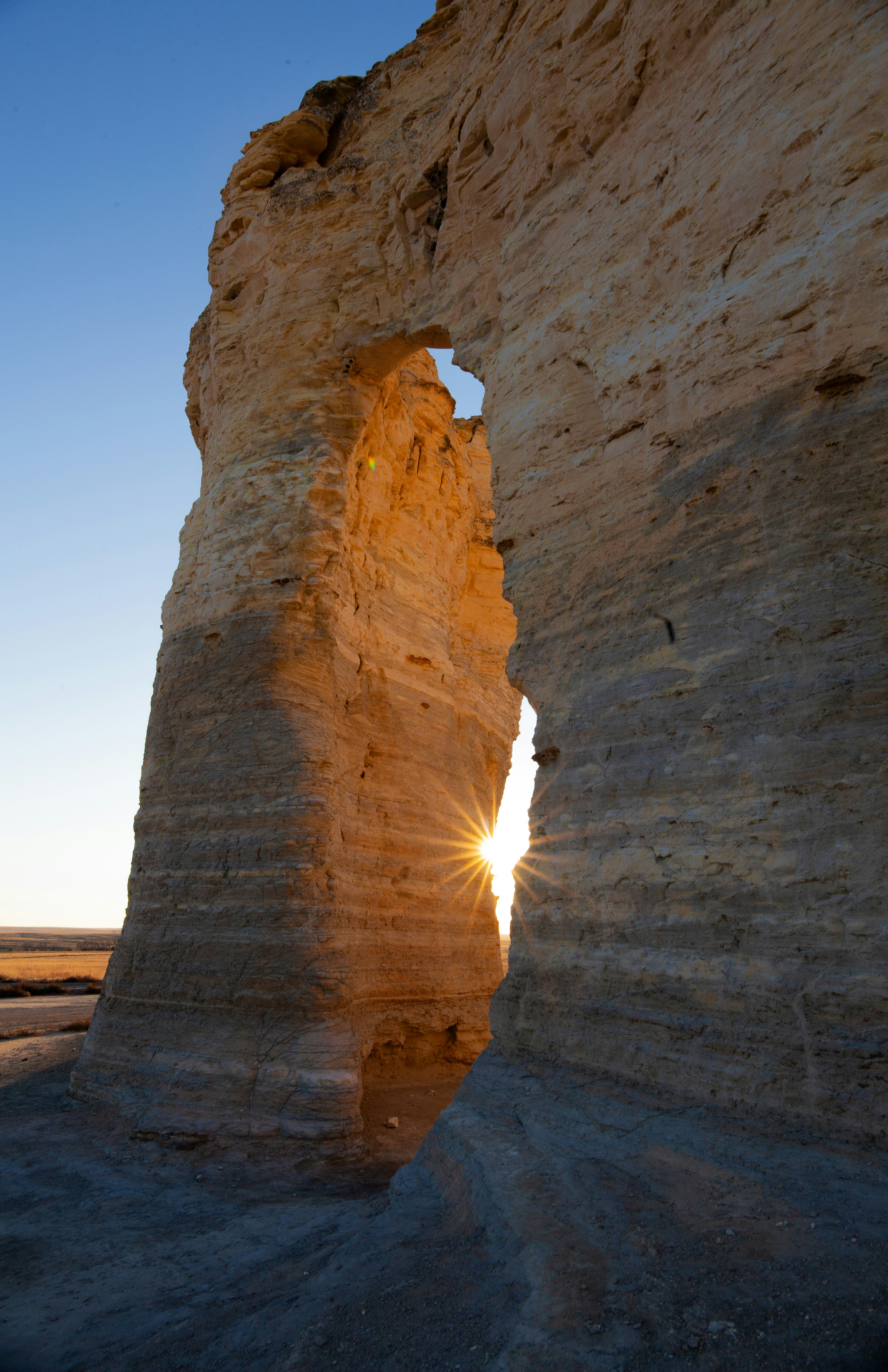 The sun is shining through a crack in the rock