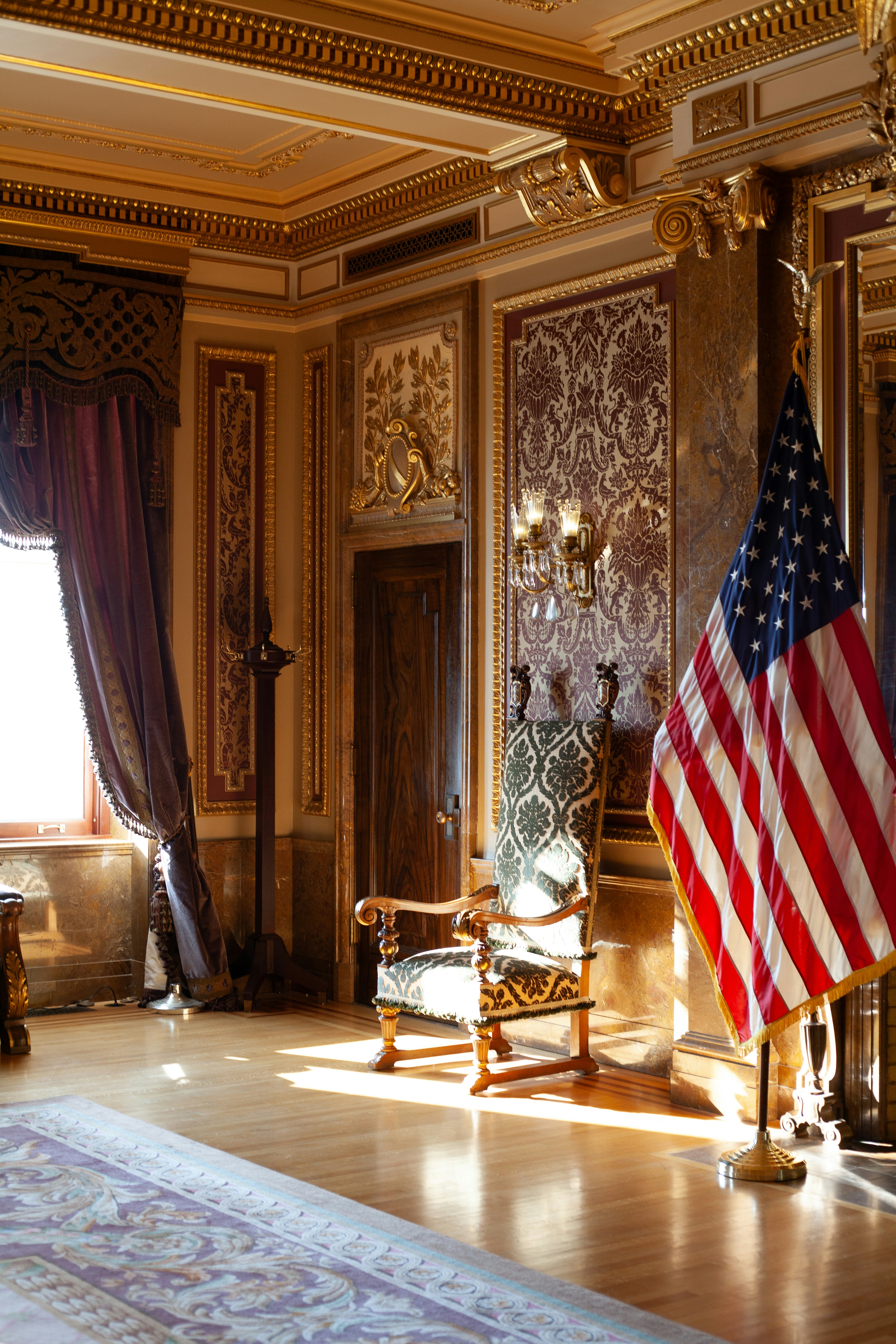 A room with a large american flag hanging from the ceiling