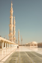 A large white building with a tall tower in the background