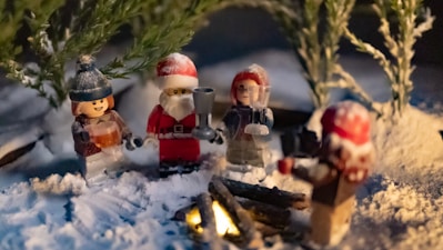 A group of christmas figurines sitting in the snow
