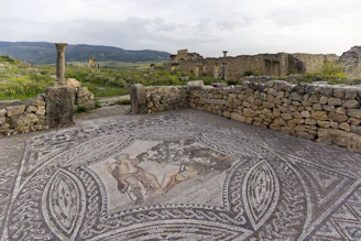 A mosaic in the middle of a stone floor