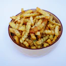 A white bowl filled with french fries on top of a table