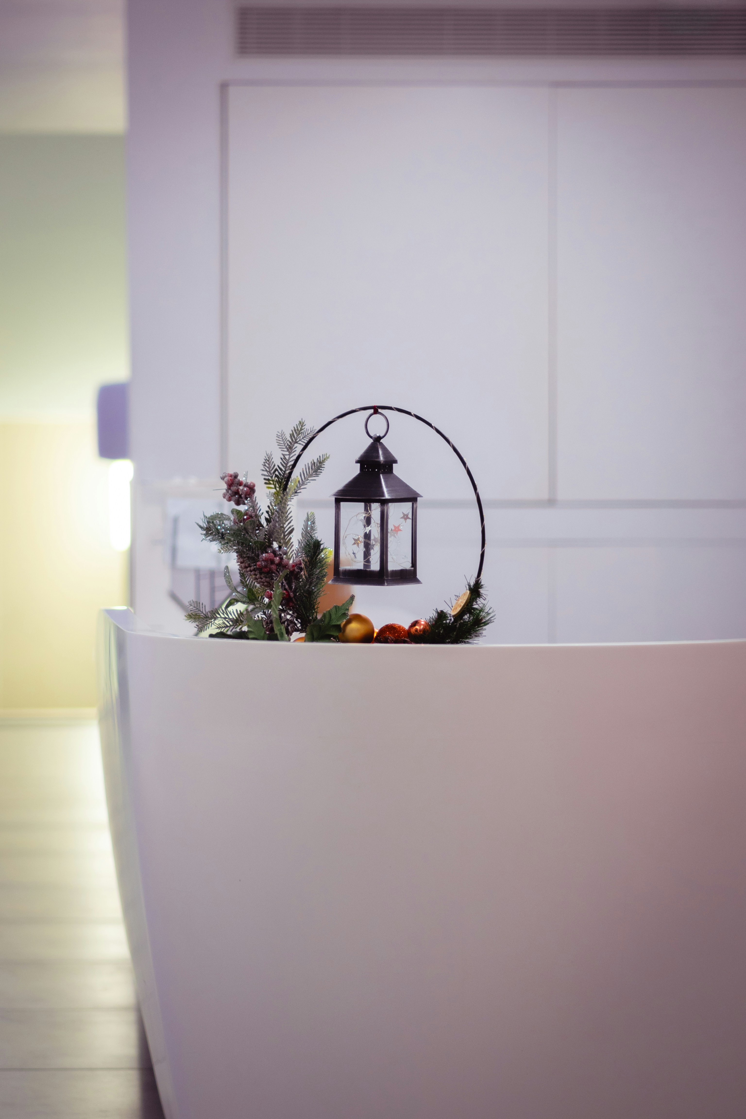 A white reception table with a lantern and flowers