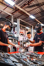 Two men working on a machine in a factory