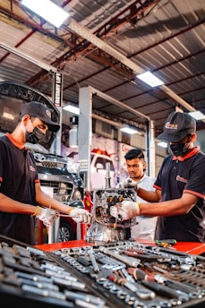 Two men working on a machine in a factory