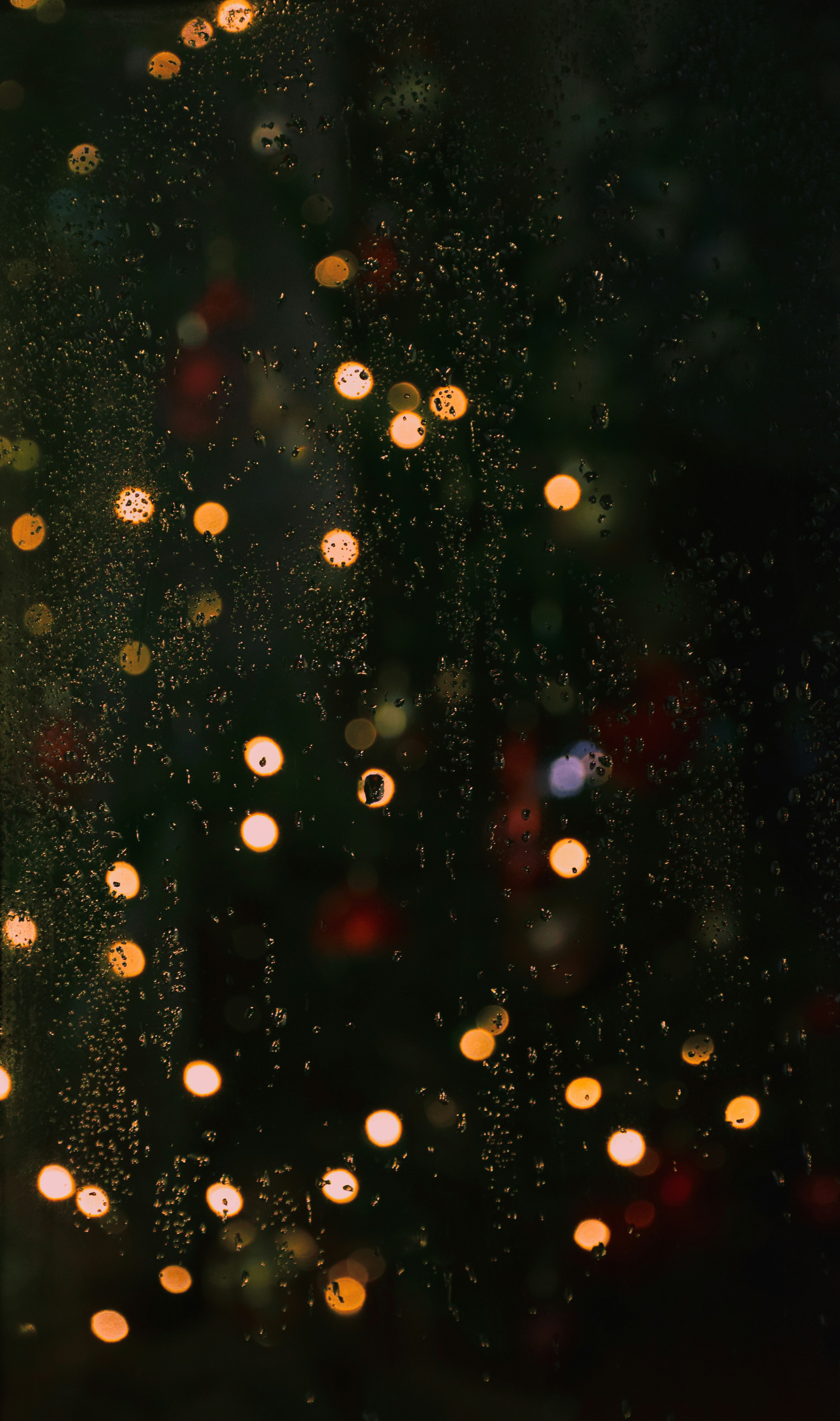 Rain drops on a window with a blurry background