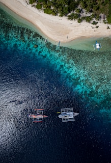 A group of boats floating on top of a body of water