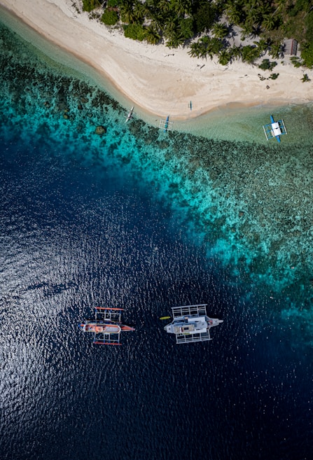 A group of boats floating on top of a body of water
