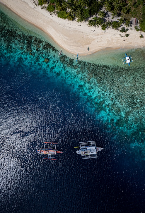 A group of boats floating on top of a body of water