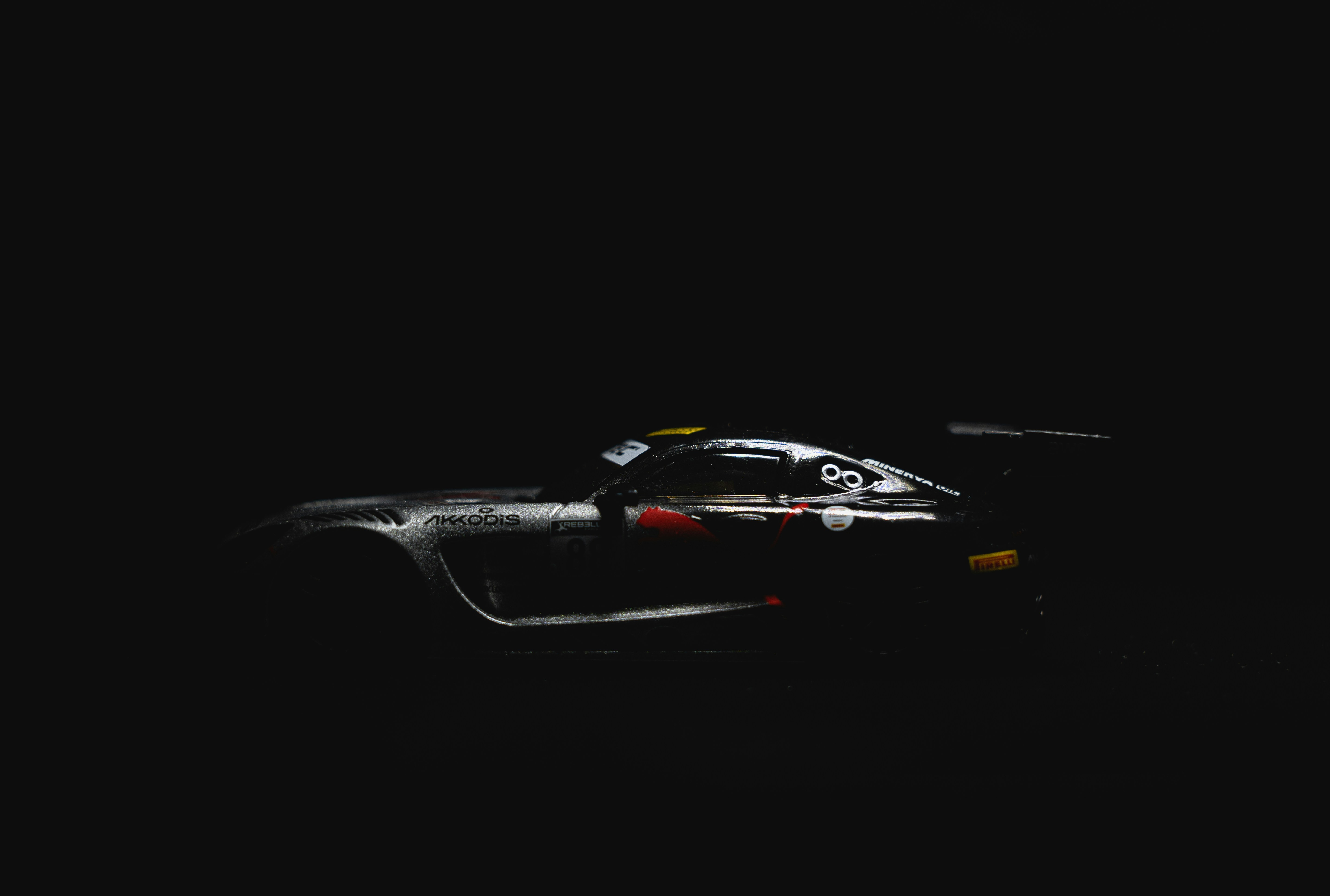 A racing car is shown in the dark